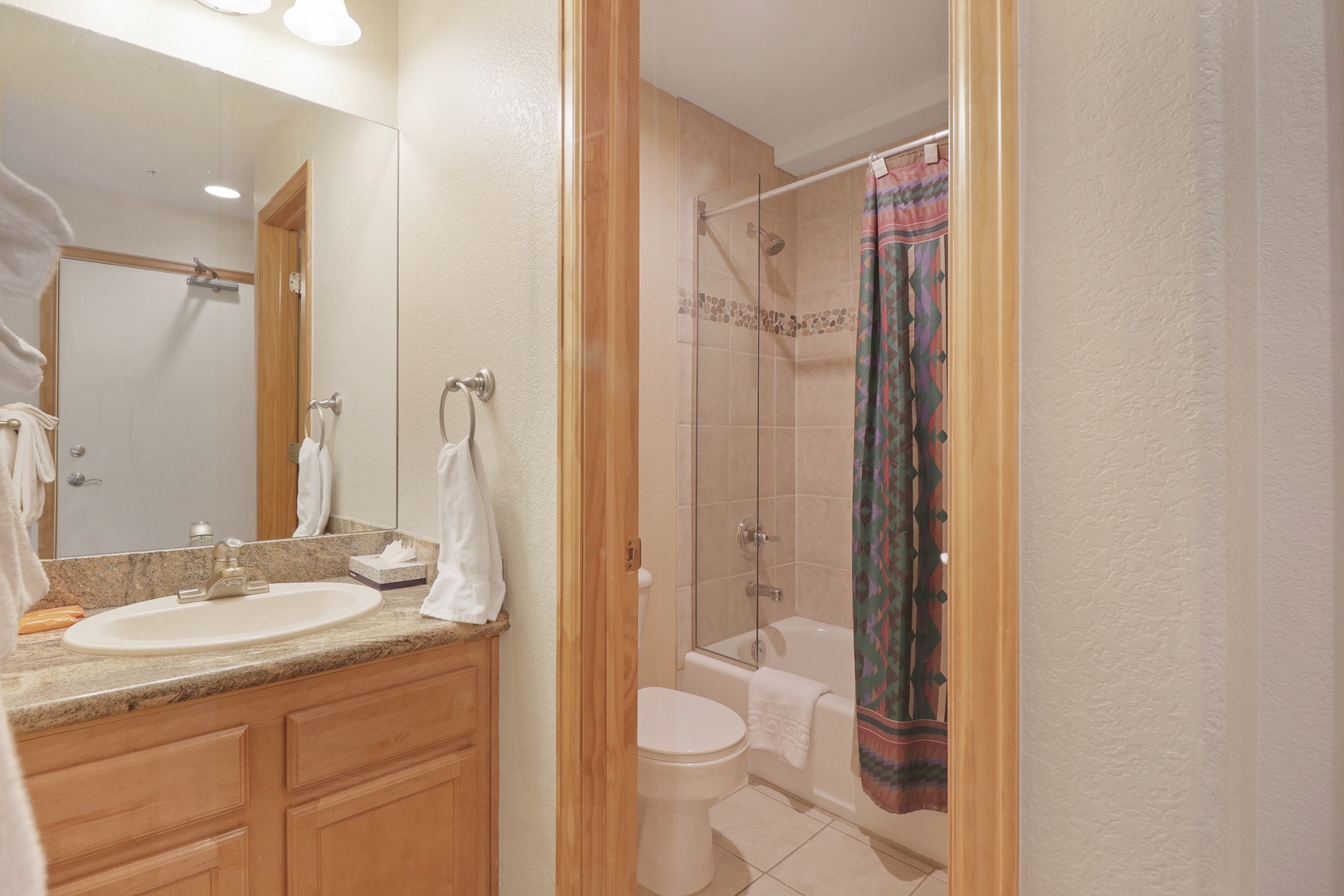 Your private bathroom features warm wood finishes, granite counters, and a relaxing tub-shower combo—perfect for unwinding after a day of adventure.