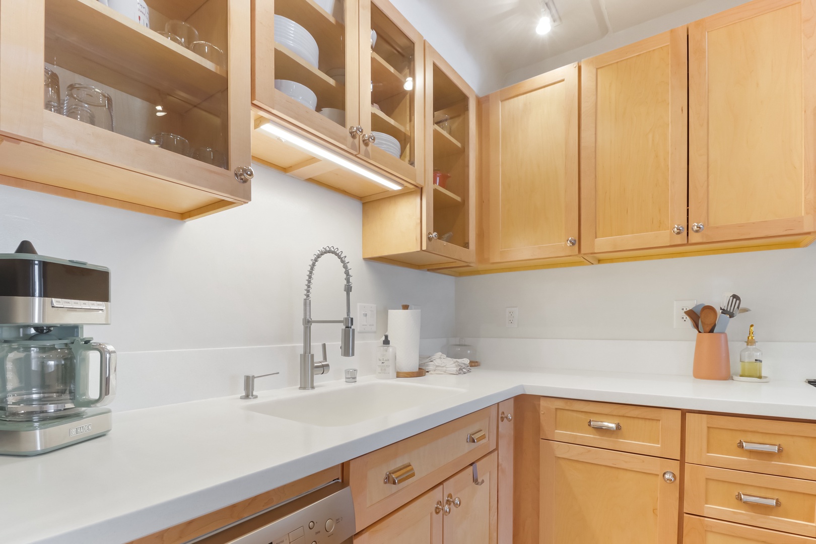 Your fully equipped kitchen awaits with warm wood cabinetry, gleaming countertops, and everything you need to create memorable meals during your stay.