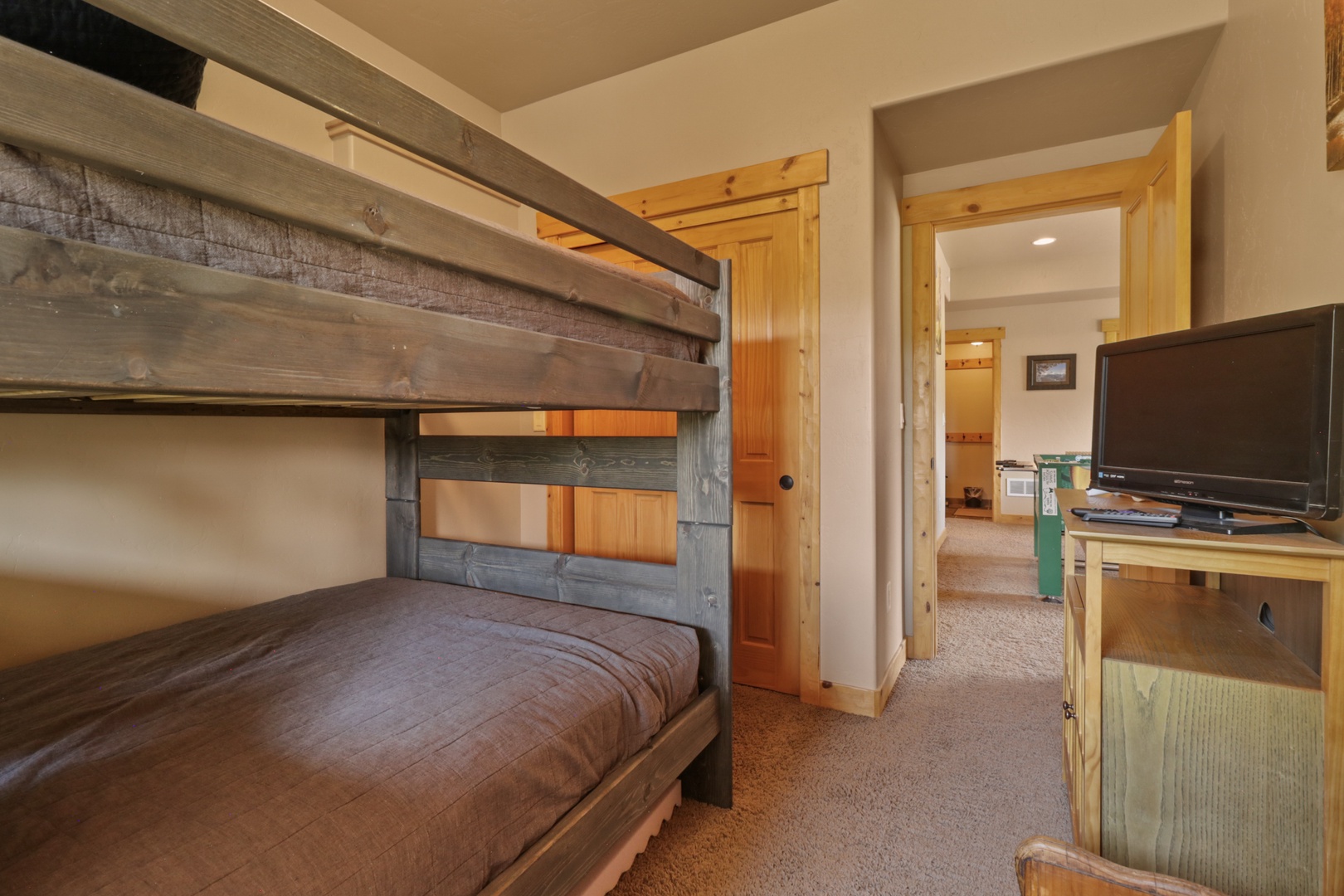 Your kids will love the rustic charm of this cozy bunk room, with sturdy handcrafted bunks and warm wood details that create a welcoming retreat for restful mountain nights.