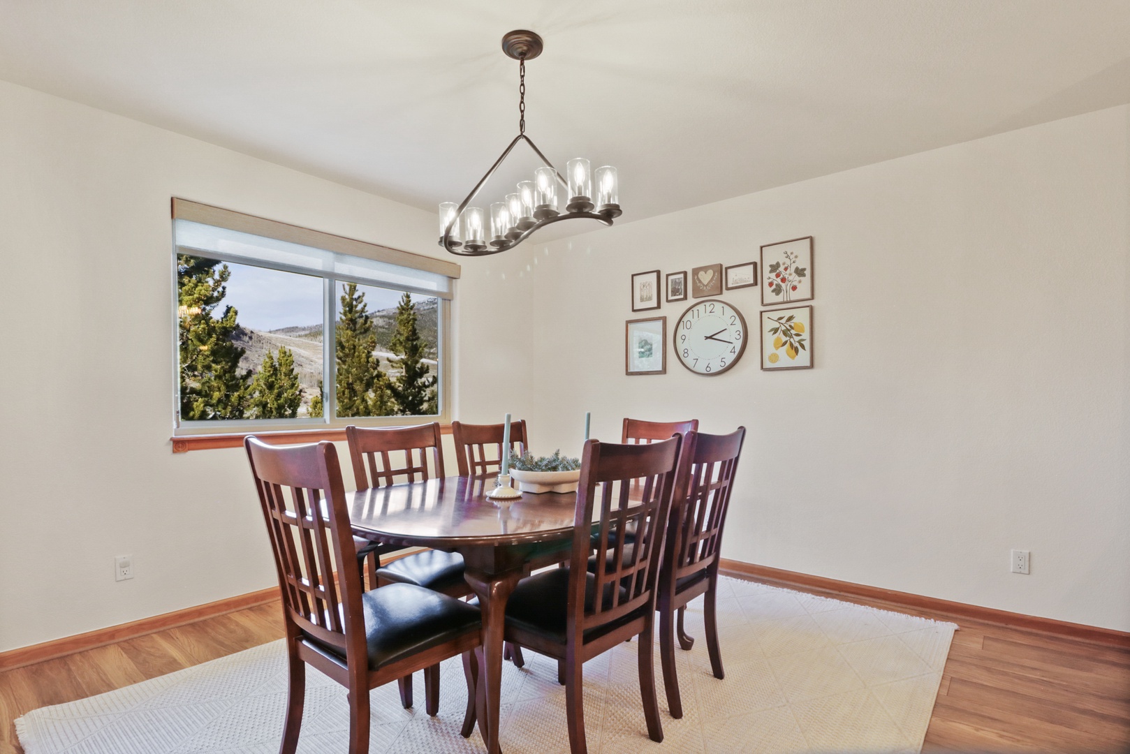 Gather around your elegant dining table, where warm wood tones and mountain views create the perfect setting for memorable meals together.
