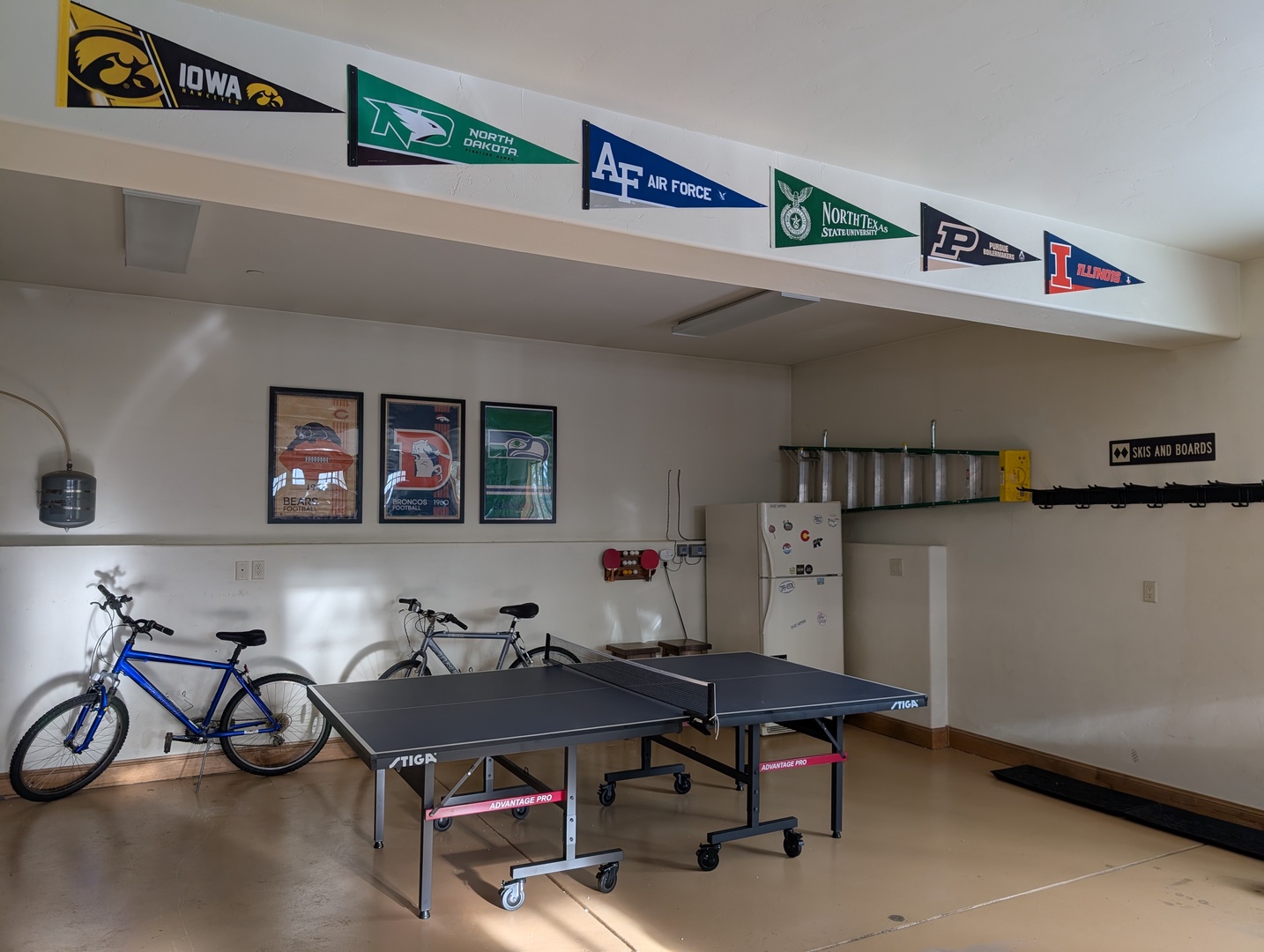 Your personal game room awaits with ping pong, bikes, and college memorabilia creating the perfect hangout space.