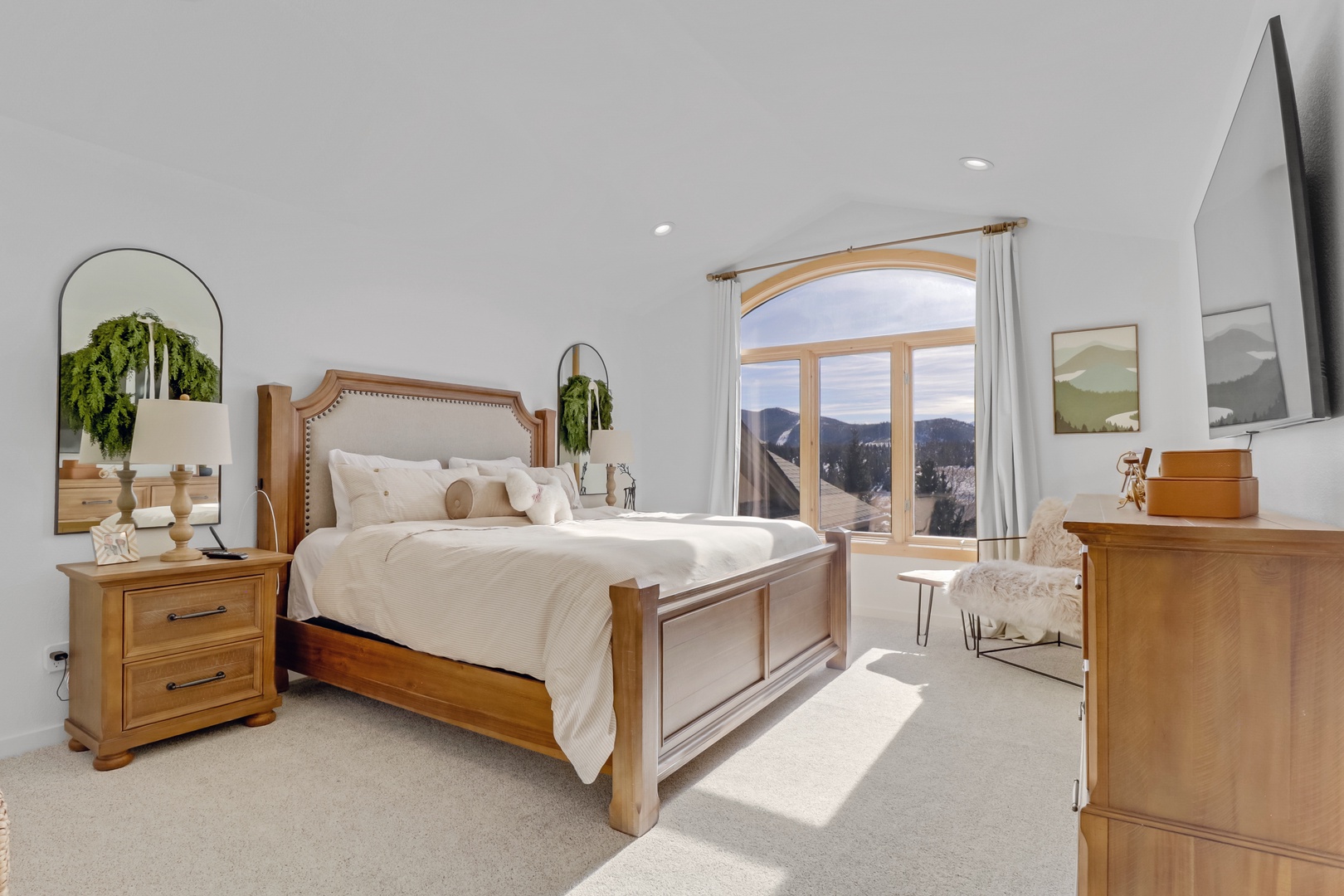 Wake up to stunning mountain views from your elegant bedroom with warm wood furnishings and crisp white linens.
