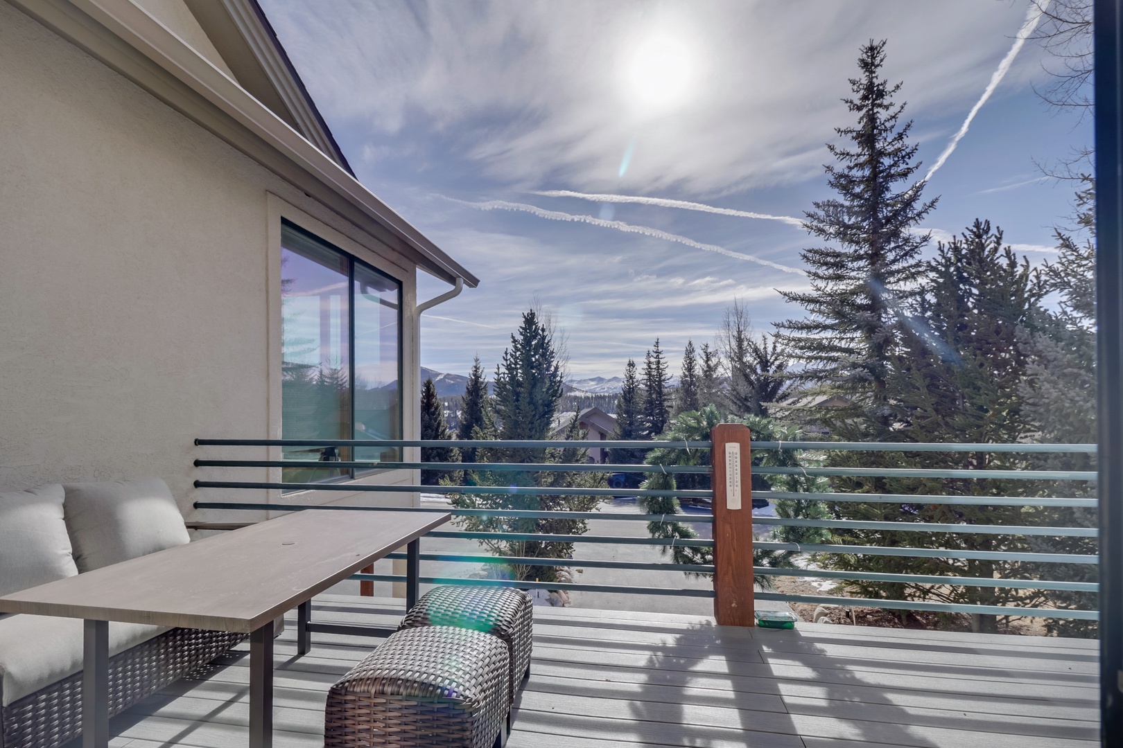 Sip your morning coffee on this private balcony while taking in stunning mountain vistas framed by towering evergreens.