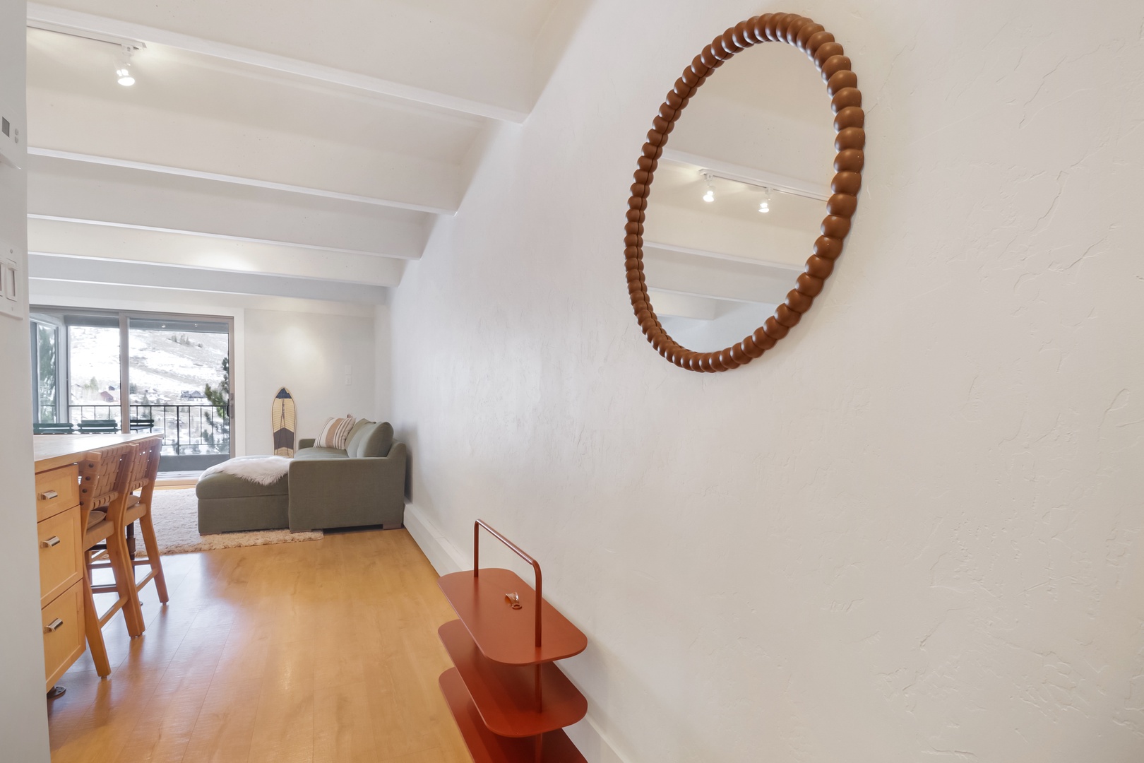 Step into your bright, modern space where exposed beams meet sleek design and natural light streams through.