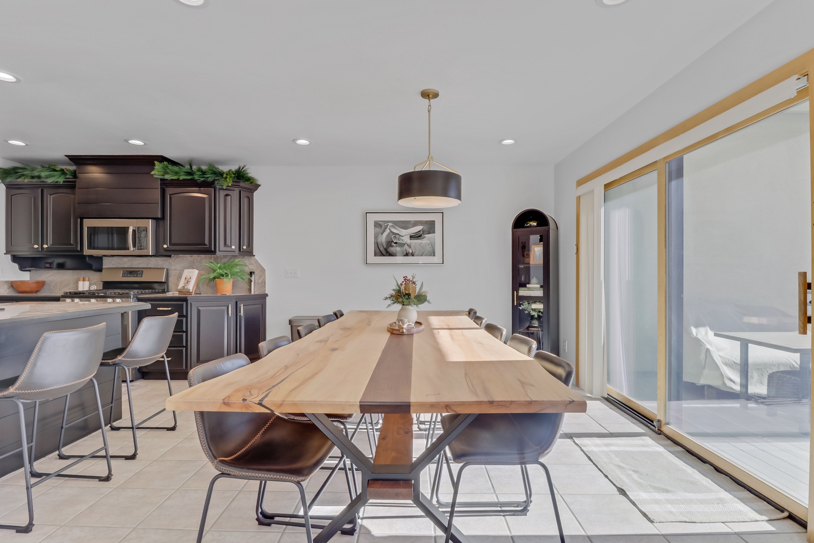 Gather around this elegant dining table where memorable meals await. Your open-concept space flows seamlessly between kitchen and dining areas.