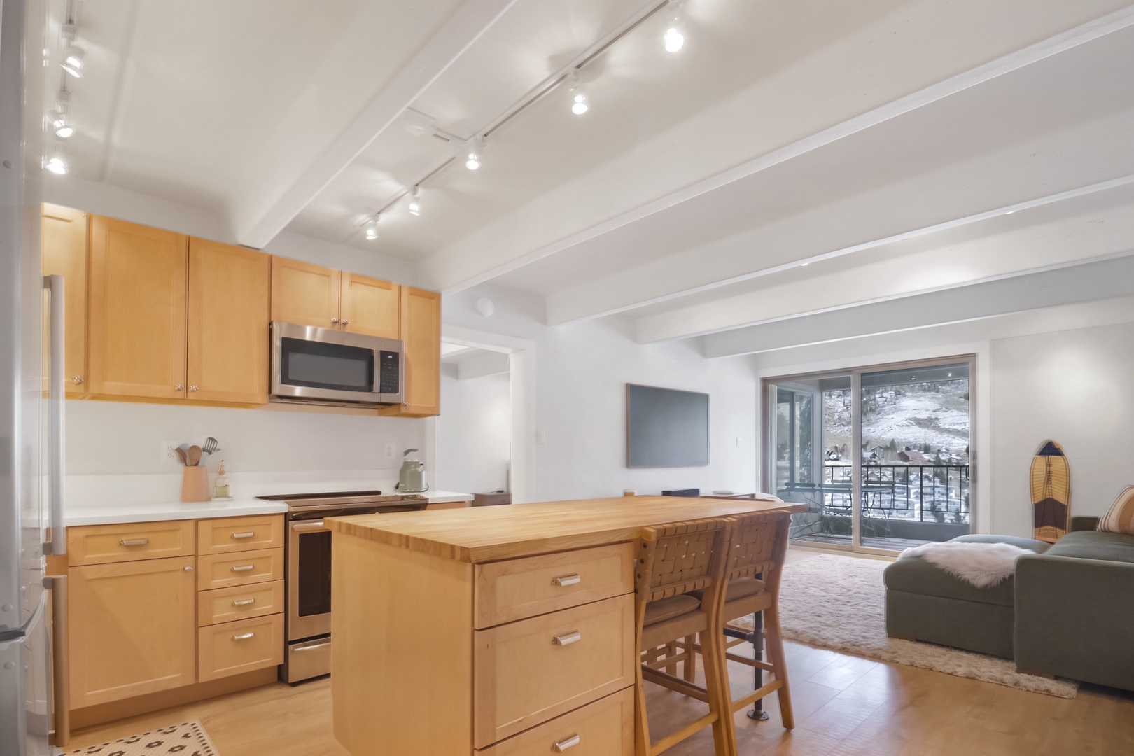 Unwind in your bright open-plan space where warm wood meets mountain views through your private balcony.