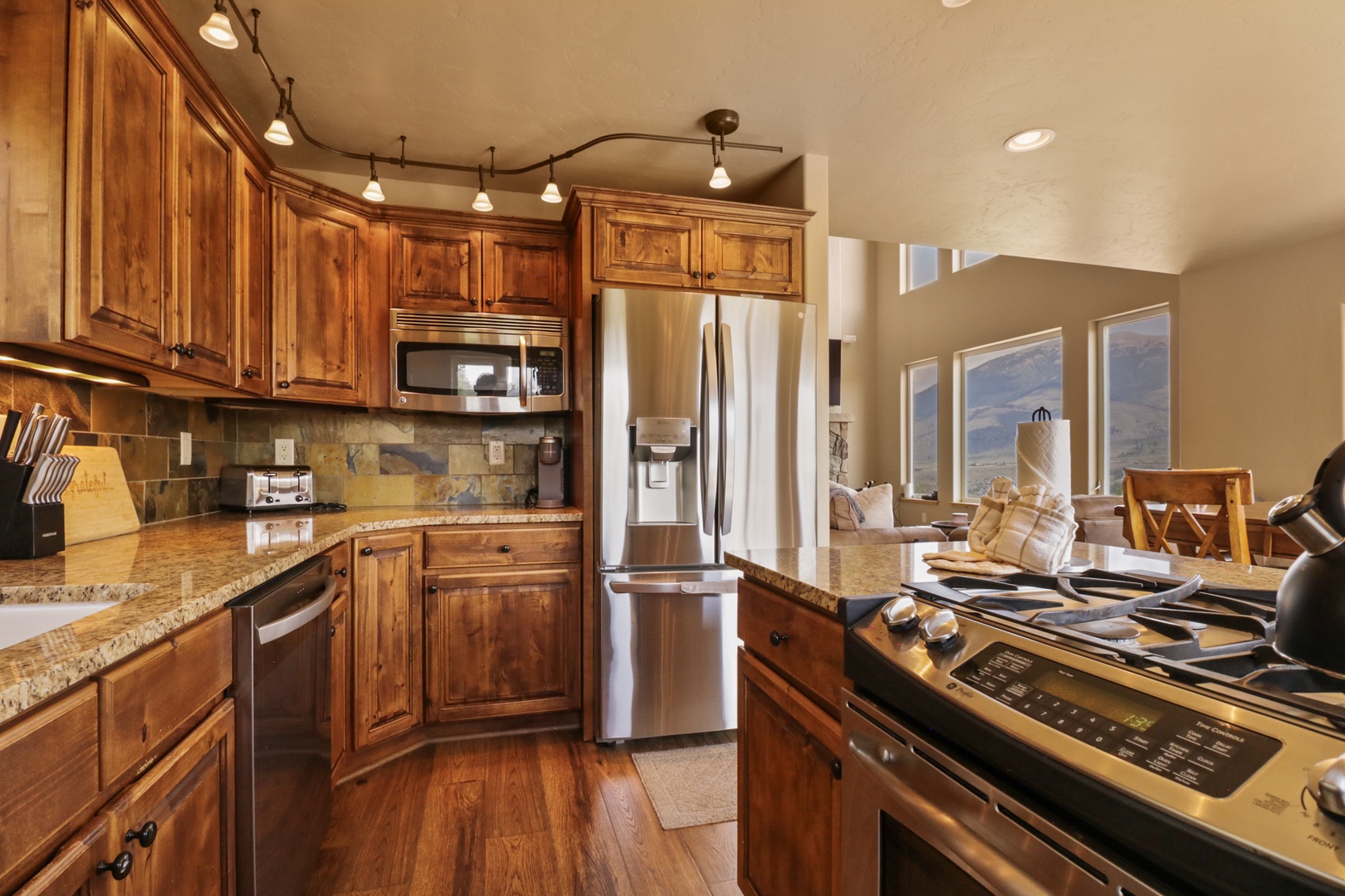 Your gourmet kitchen comes fully equipped with stainless steel appliances, granite countertops, and rich wood cabinetry—everything you need to prepare memorable meals during your mountain getaway.