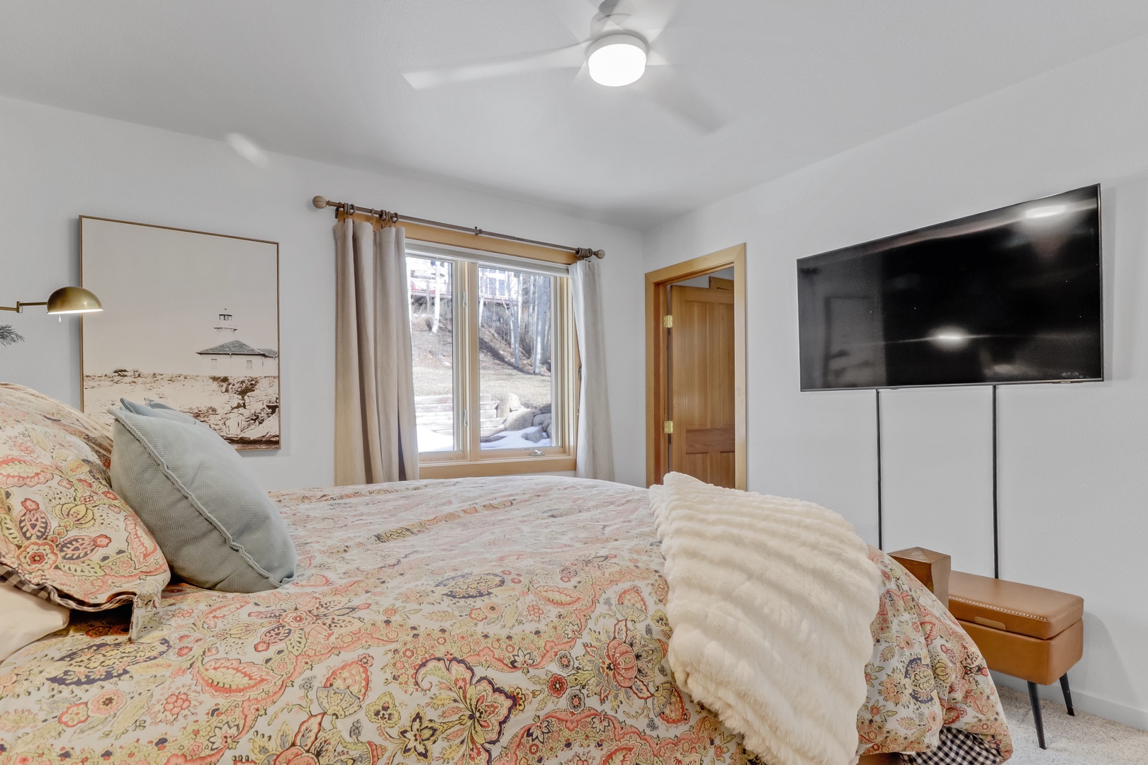 Unwind in your peaceful bedroom with plush bedding, natural light, and modern amenities for a perfect mountain retreat.