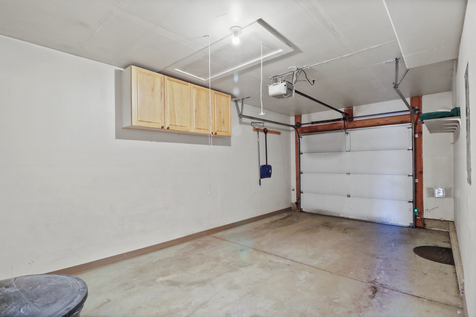 Clean, spacious garage with convenient storage cabinets and automatic door opener for your rental car and belongings.