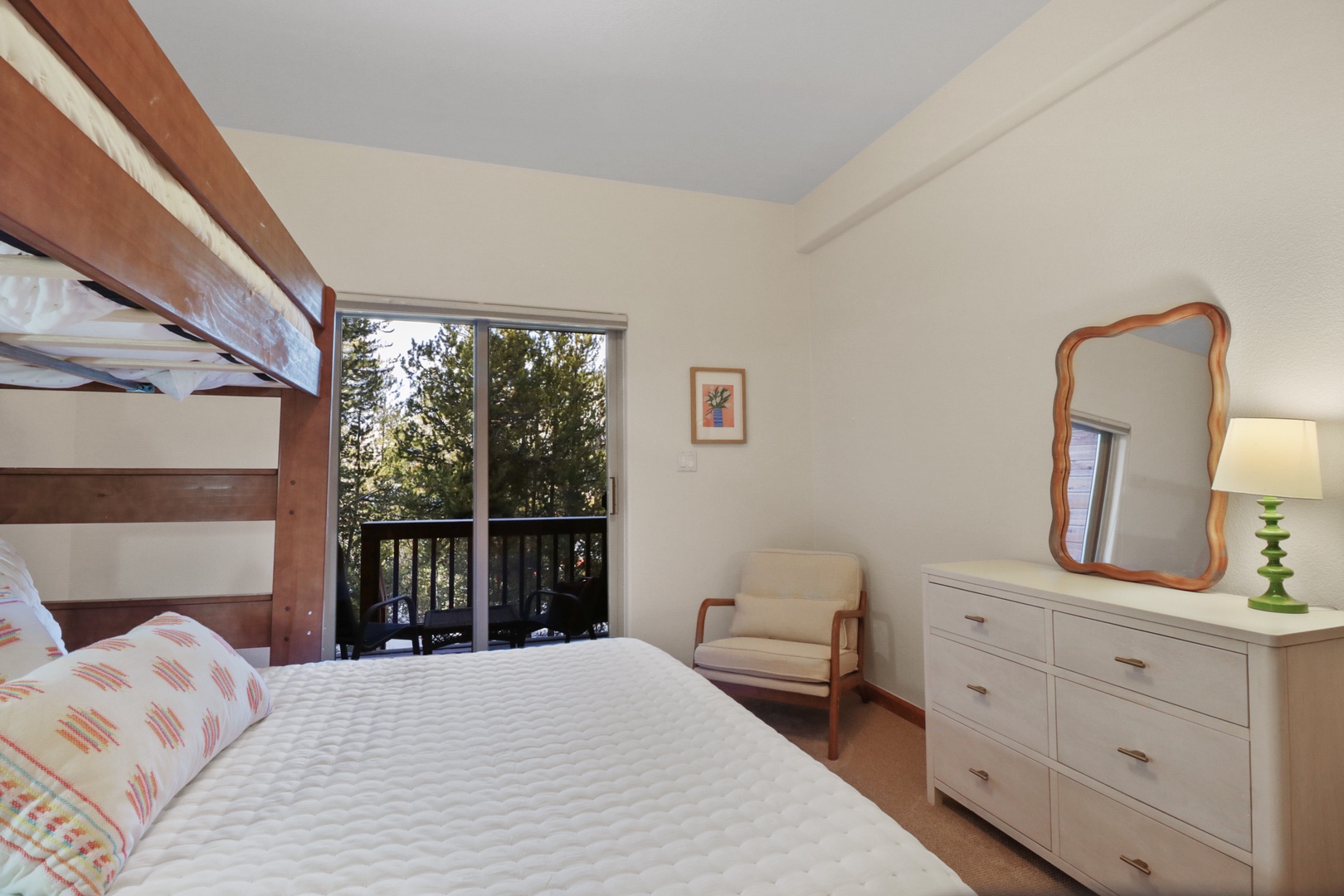 Wake up in your cozy retreat with treetop views through the private balcony doors and ample storage for your belongings.