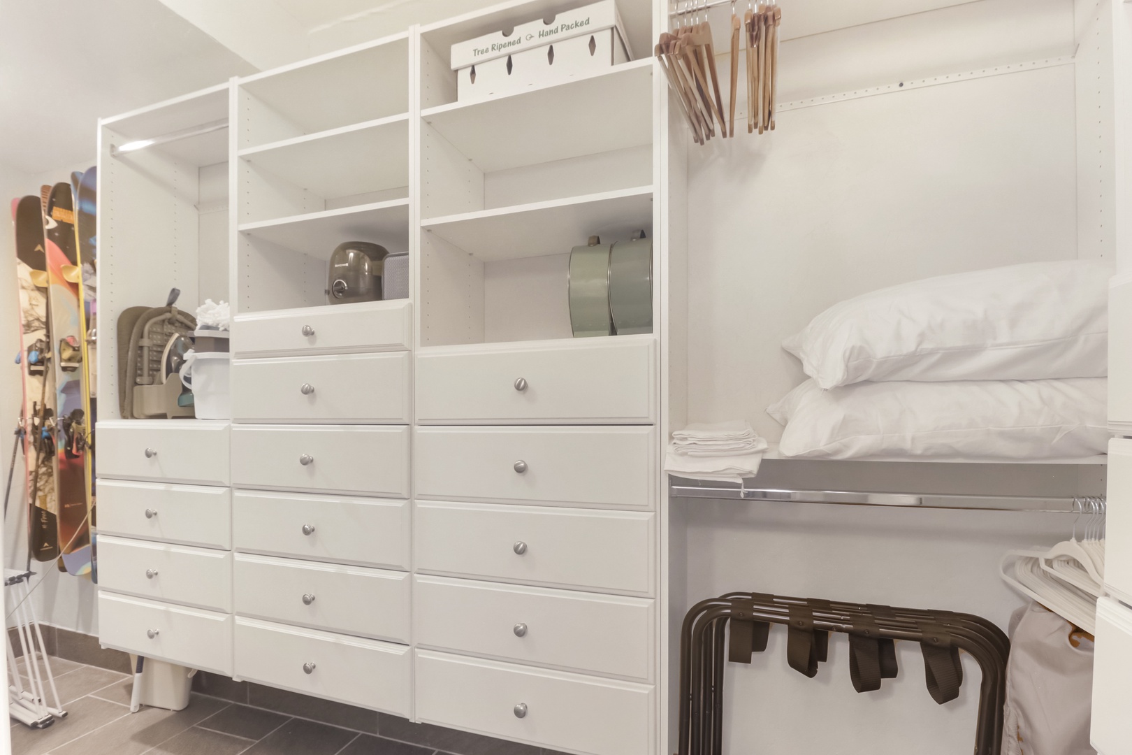 Your spacious walk-in closet offers abundant storage with built-in drawers, shelving, and hanging space for all your belongings.