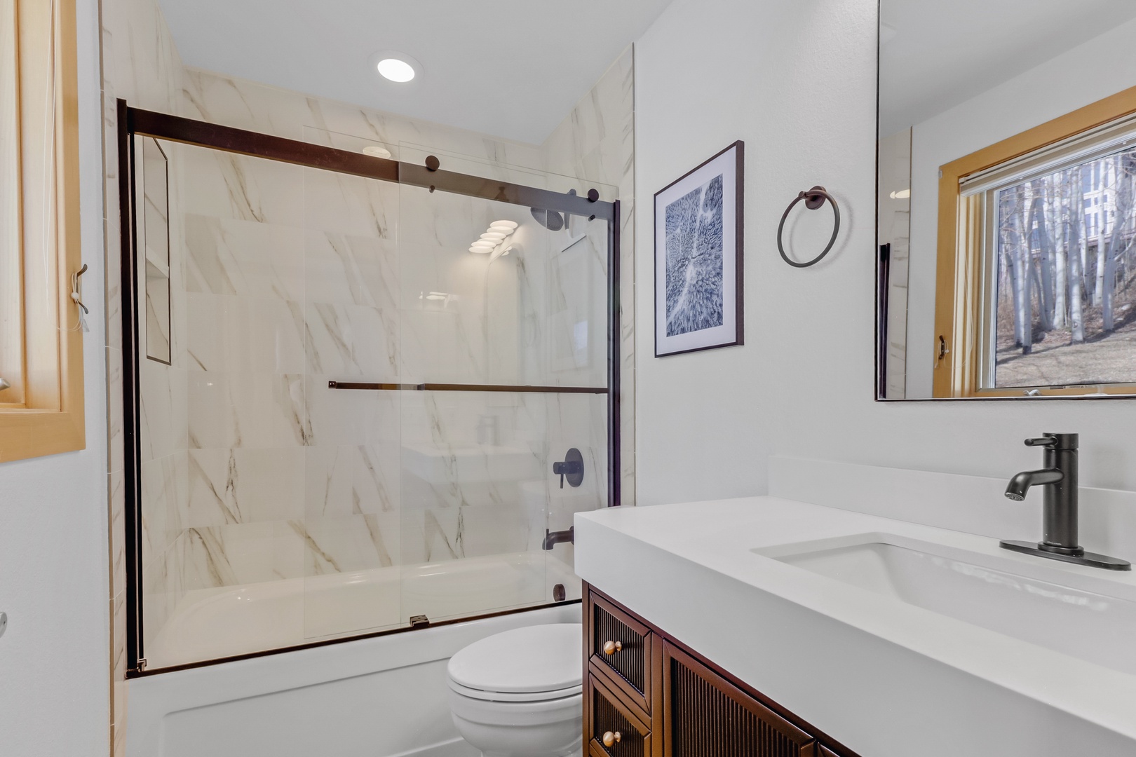 Luxurious bathroom with heated floors and shower/ tub for your spa-like retreat.