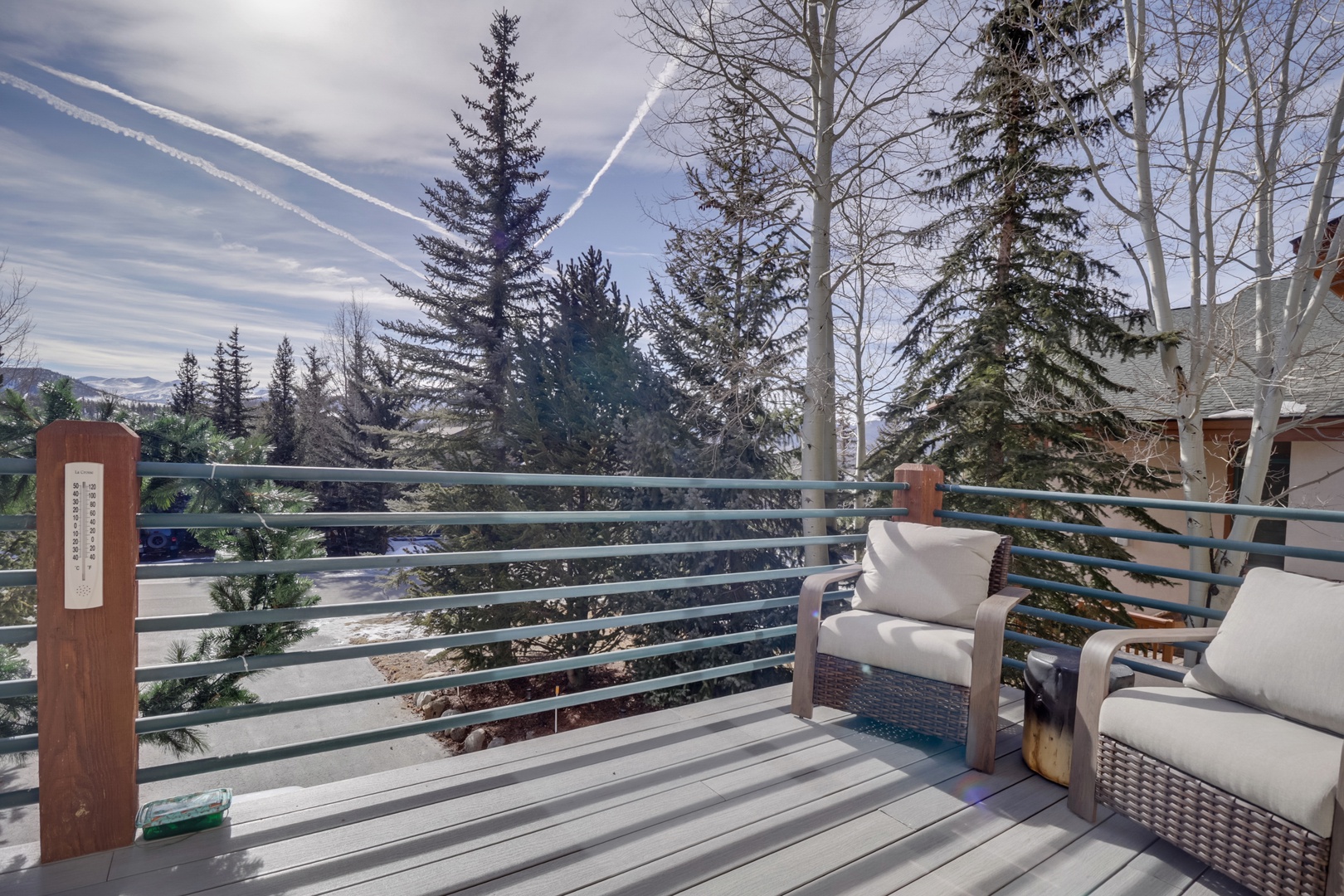 Unwind on your private deck with plush seating while soaking in sweeping mountain views through towering evergreens.