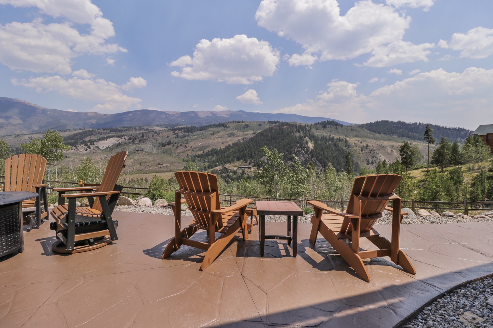 Unwind in your own Adirondack chairs while soaking up sweeping mountain vistas. This peaceful terrace offers the perfect spot to savor morning coffee or evening conversations surrounded by nature's grandeur.