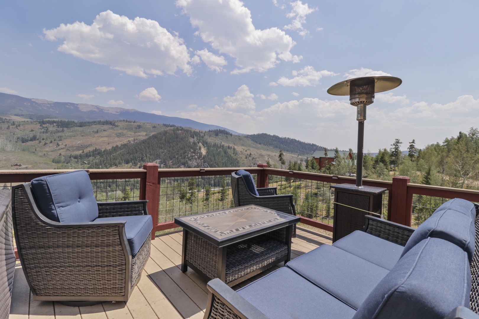 Scenic mountain views stretch across the horizon from this elevated deck, surrounded by rolling hills and valleys. The comfortable seating area is designed to help guests unwind and soak in the natural beauty.