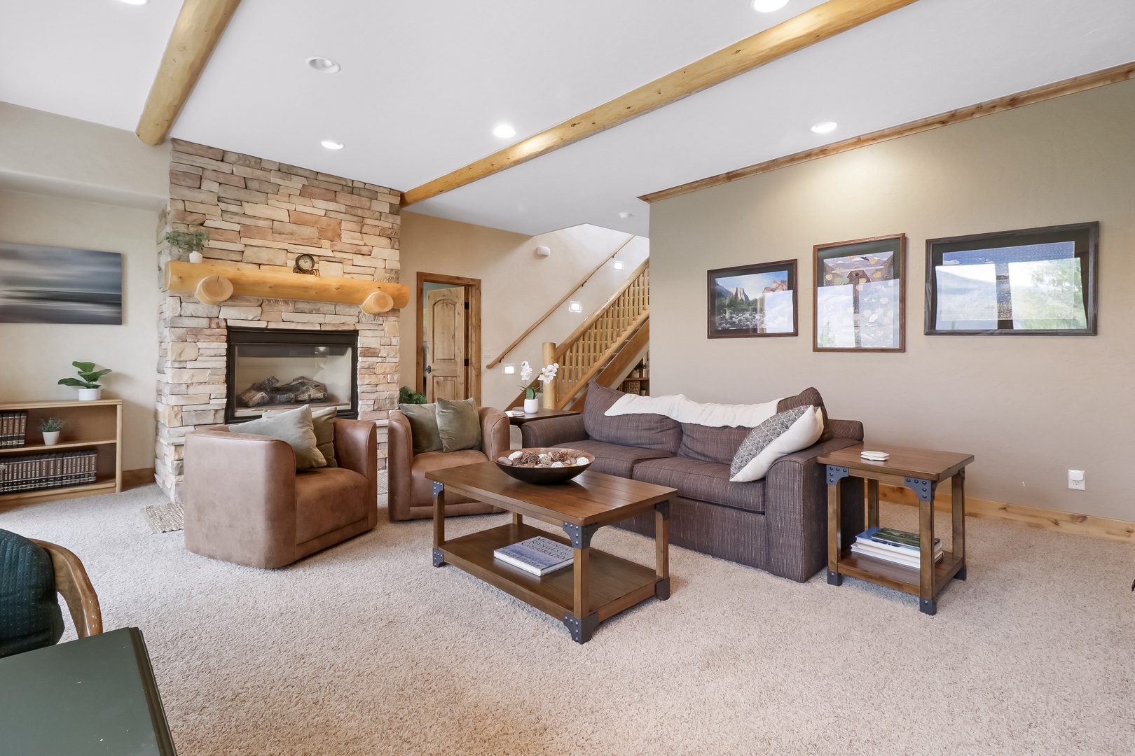 Settle in with a good book by the warm fireplace or stretch out on plush seating beneath vaulted wood-beam ceilings—your mountain retreat awaits.