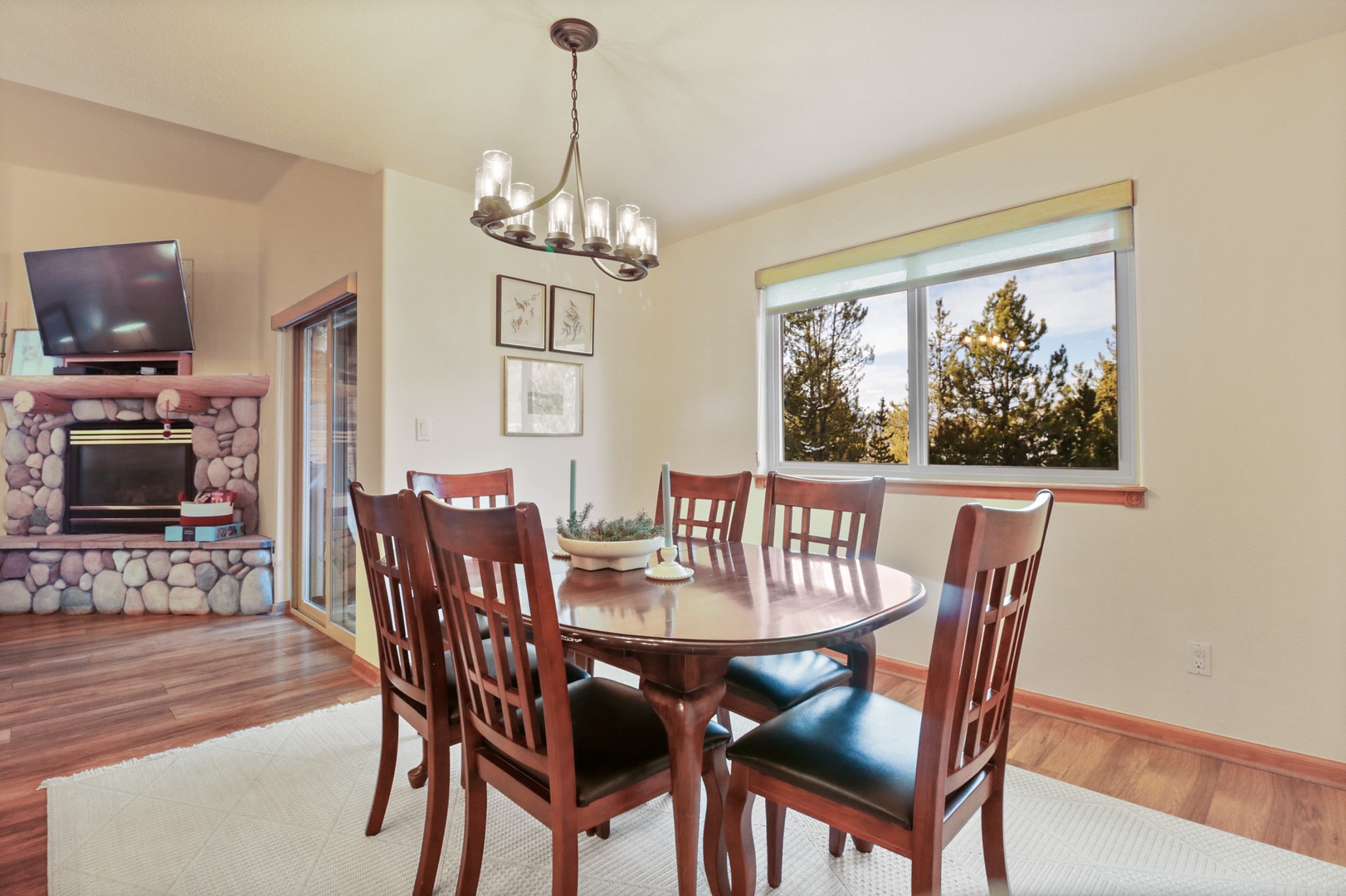 Gather around this inviting dining table where you'll share memorable meals with loved ones, warmed by the cozy fireplace nearby.