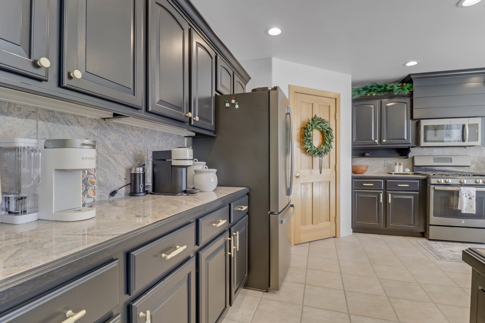 Your spacious kitchen features black cabinets, quartz counters, and stainless appliances—perfect for preparing memorable meals during your stay.