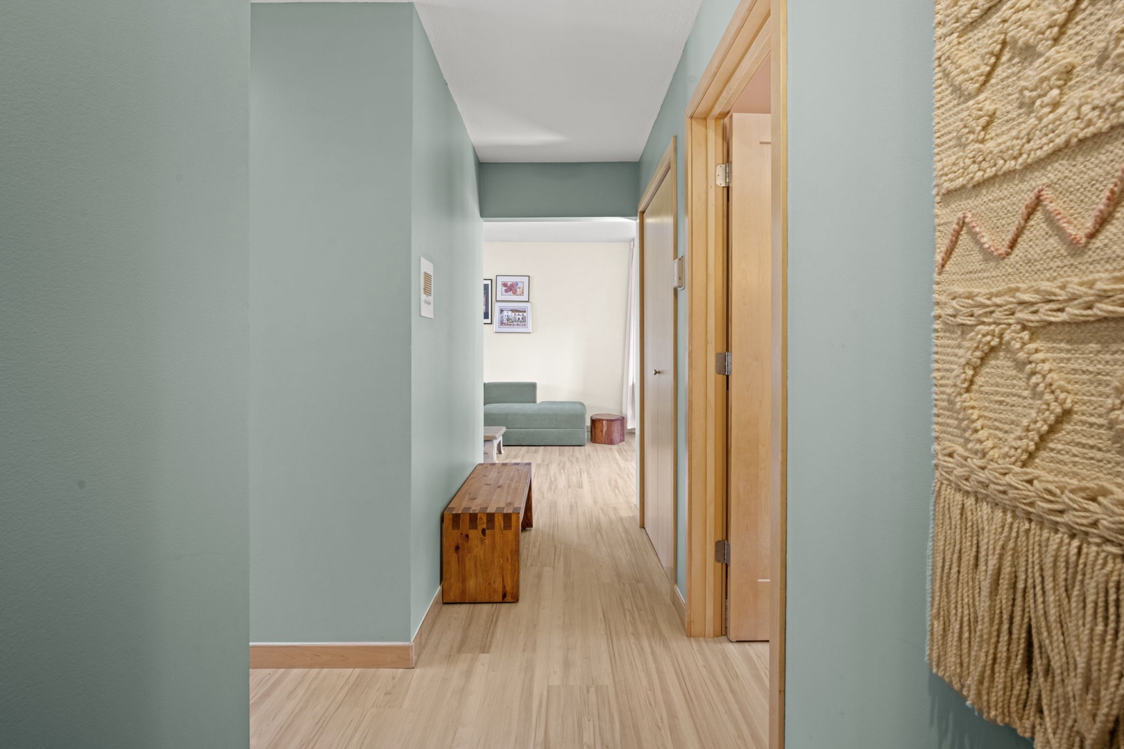 Step into your serene retreat with calming sage walls, light wood accents, and cozy spaces that invite you to unwind and feel right at home.