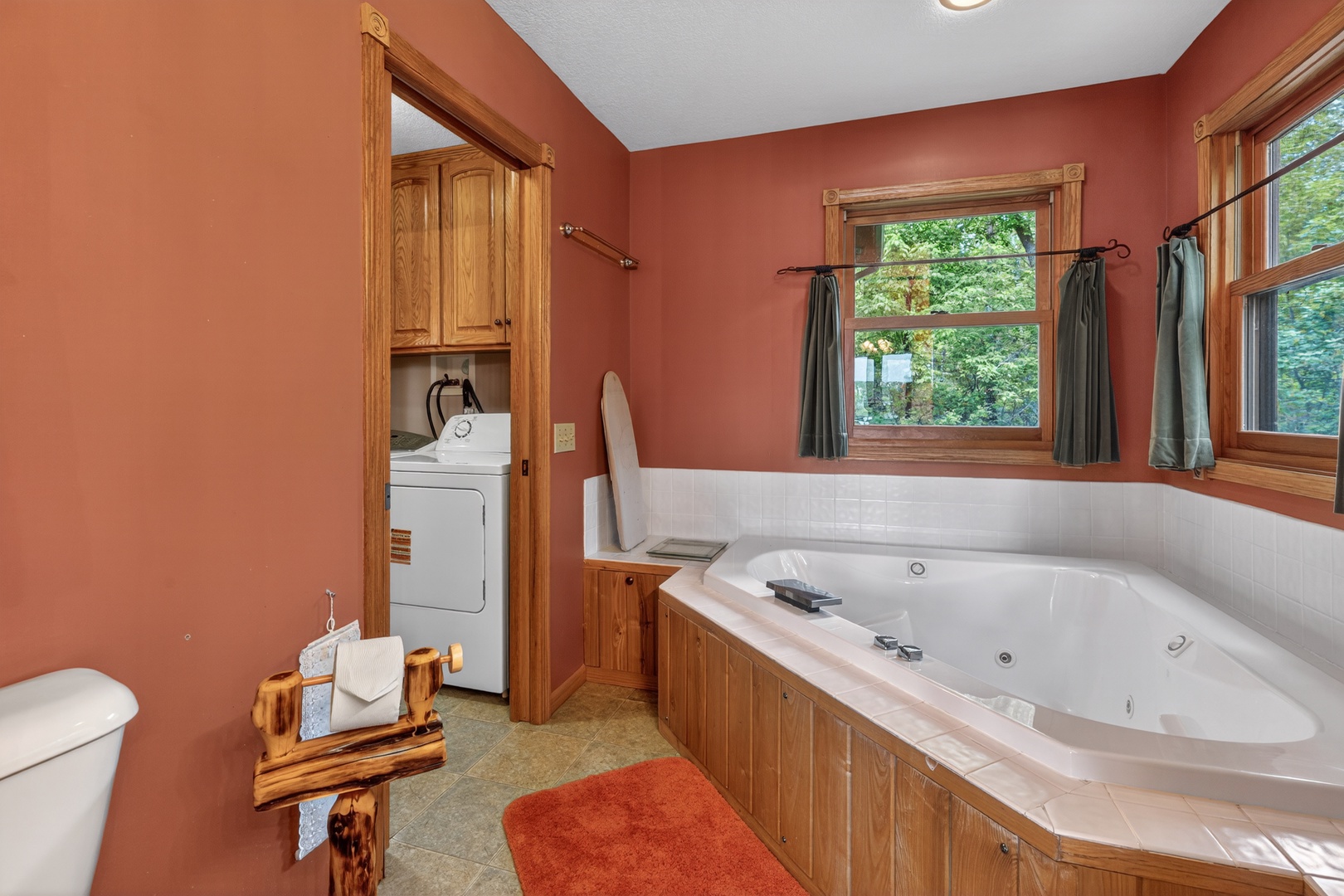 Unwind in your private jetted tub surrounded by warm wood accents and natural light from garden views, with in-suite laundry for added convenience.