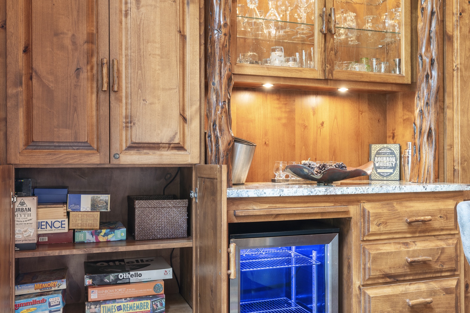 Rustic wooden cabinetry and granite countertops create a cozy bar area, perfect for storing your favorite beverages and enjoying an evening cocktail in the comfort of your retreat.