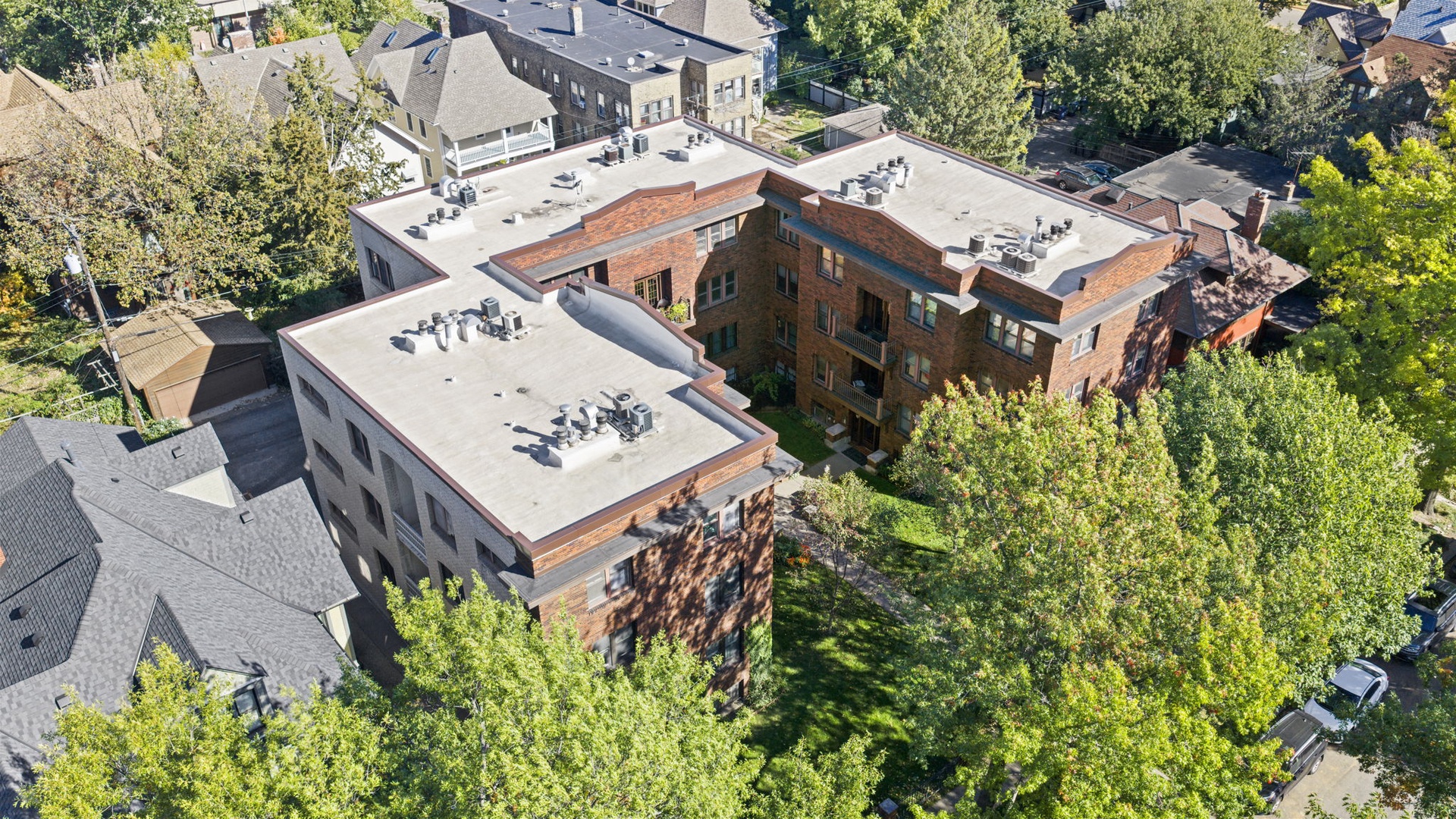 The property sits in a leafy residential neighborhood, surrounded by mature trees and quiet streets. A peaceful, tree-lined setting awaits just moments from arrival.