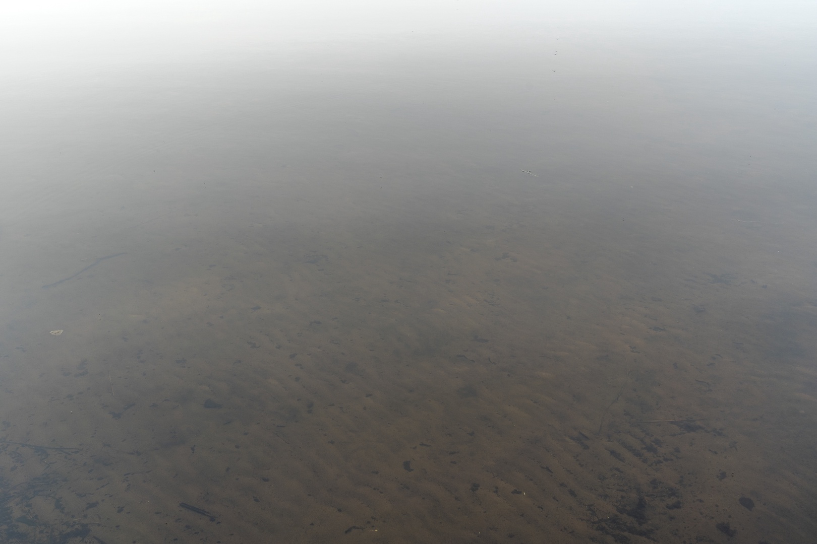 Aerial perspective of the surrounding terrain under atmospheric conditions, capturing the natural landscape around the property location.
