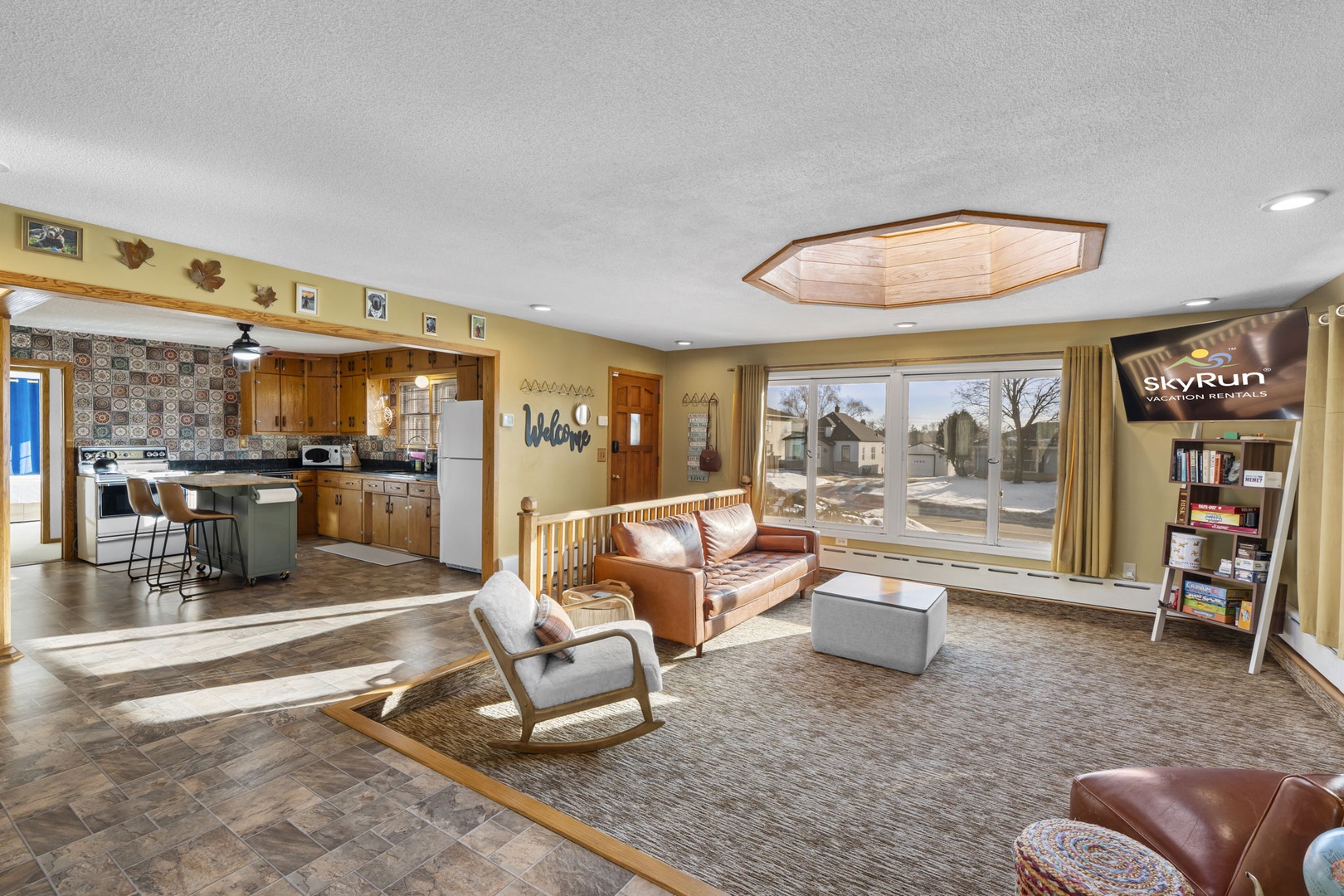 Relax in this spacious open-concept living area where warm wood and leather create the perfect retreat atmosphere for your group getaway.