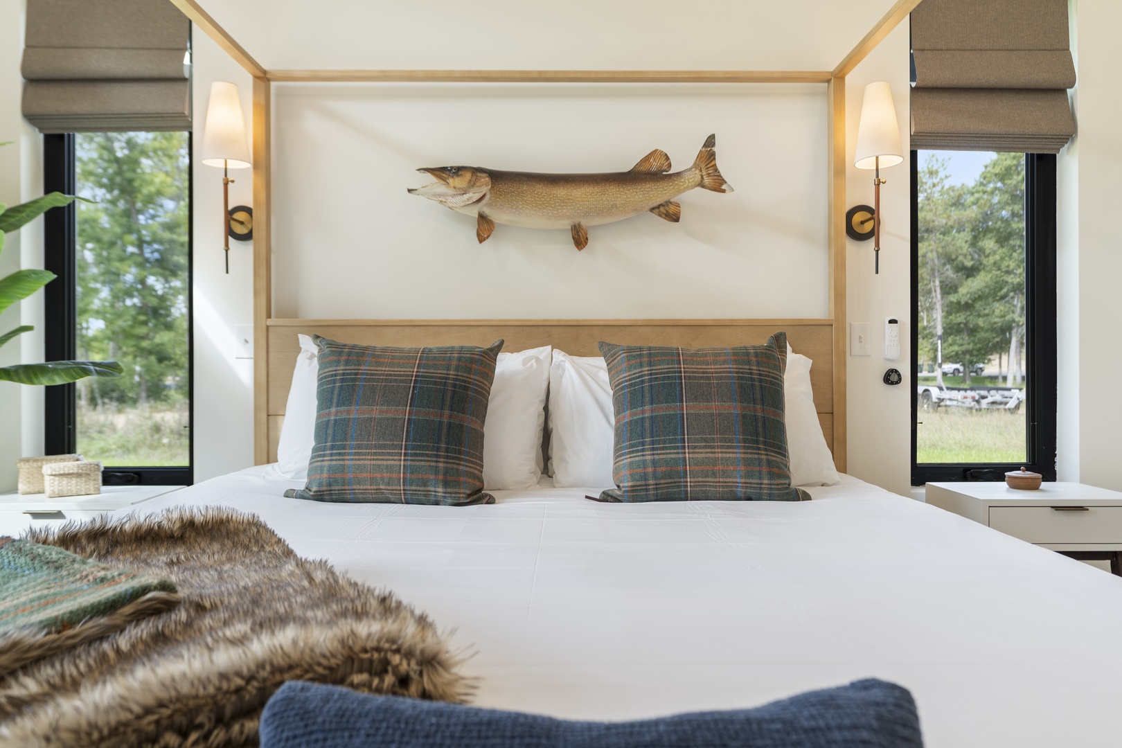 Sink into the plush comfort of your bed framed by soft natural light, crisp linens, and rustic charm—perfect after a day exploring the outdoors.