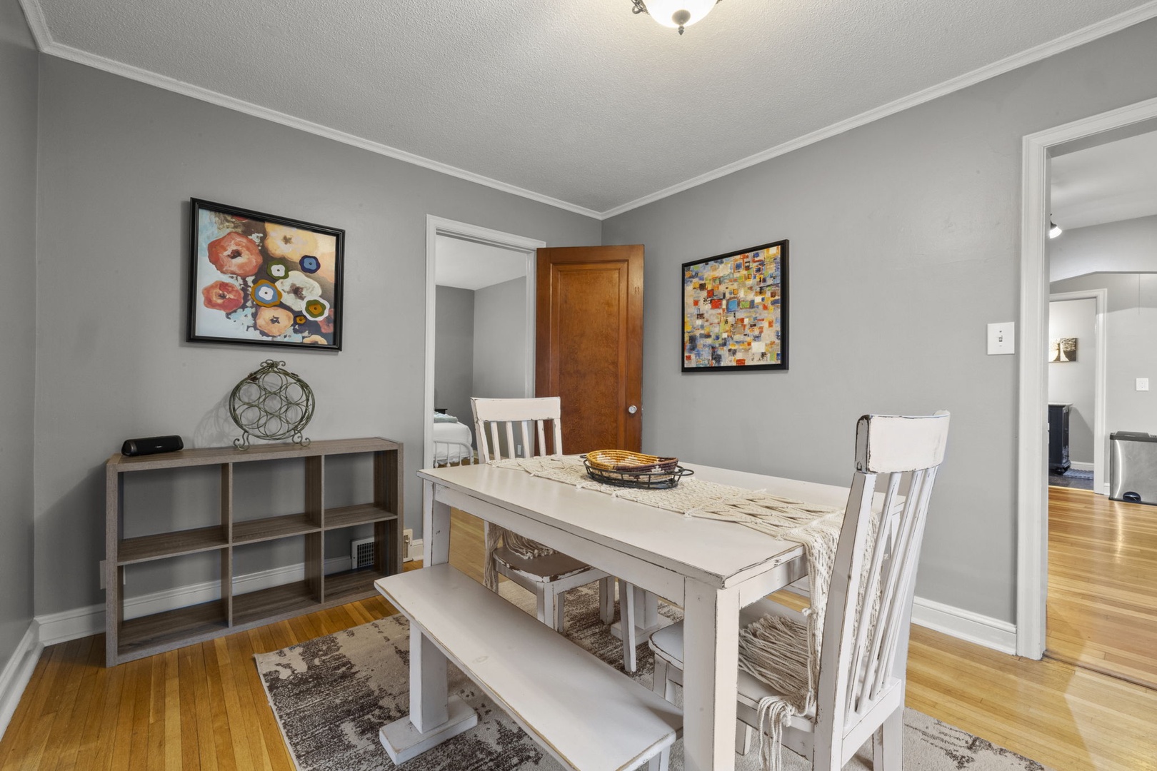 Settle into your cozy dining area, where soft gray walls and warm hardwood floors invite you to linger over morning coffee or plan your day's adventures.