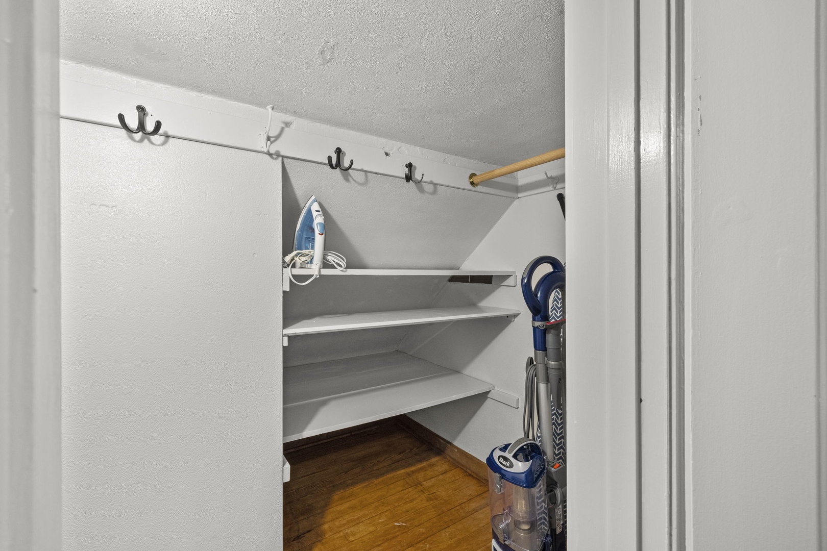 Dedicated storage closet with shelving and hooks keeps your belongings organized and accessible throughout your stay.