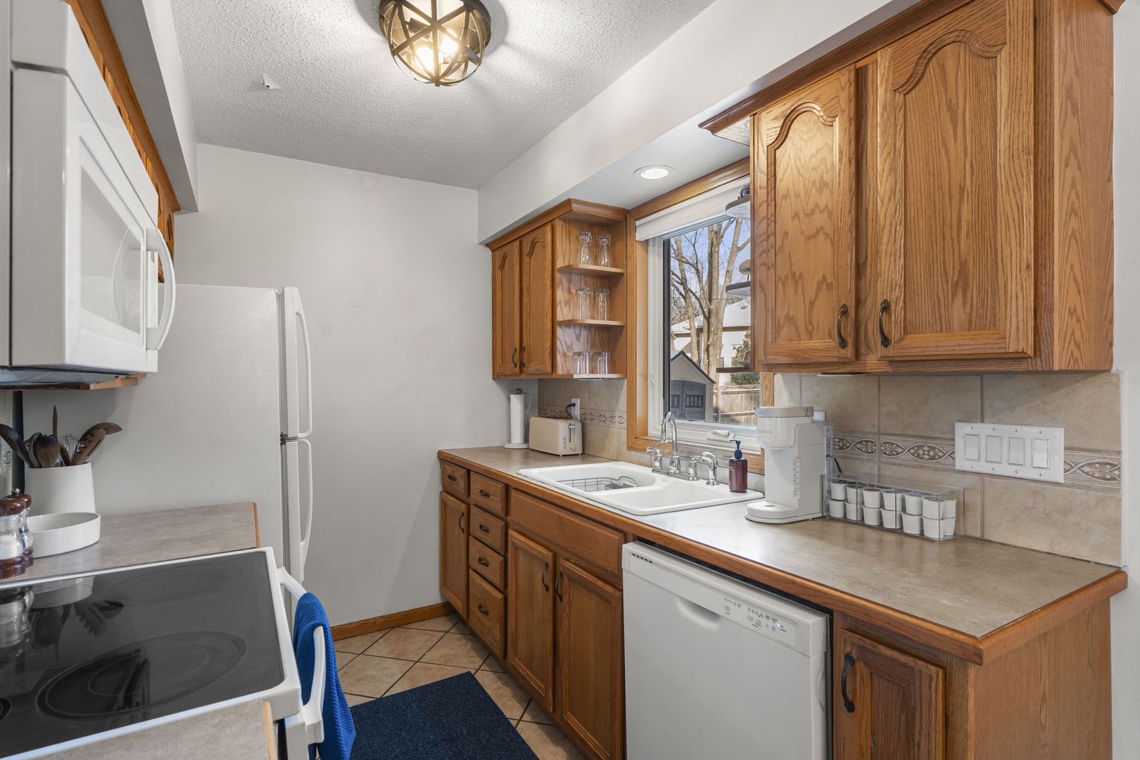 Your fully equipped kitchen awaits with rich wood cabinets, modern appliances, and everything you need to create memorable meals during your stay.