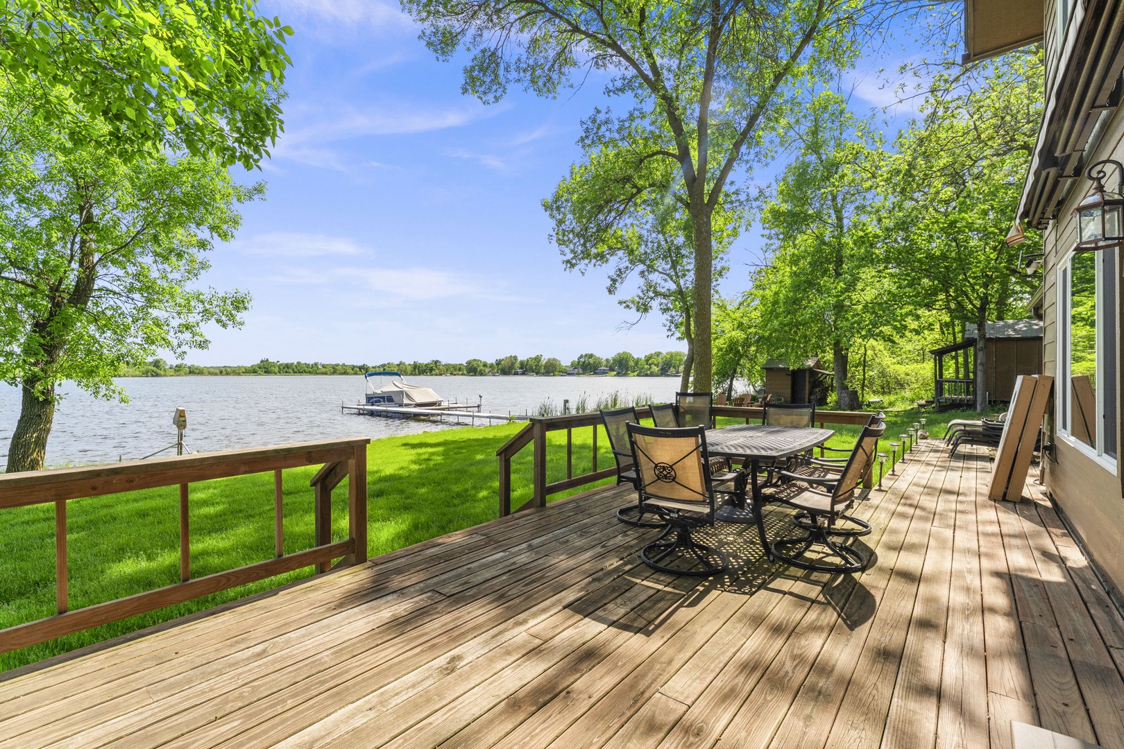 Step onto your private deck and soak in stunning lake views framed by lush greenery. Perfect for morning coffee or evening gatherings with dining space and direct waterfront access.