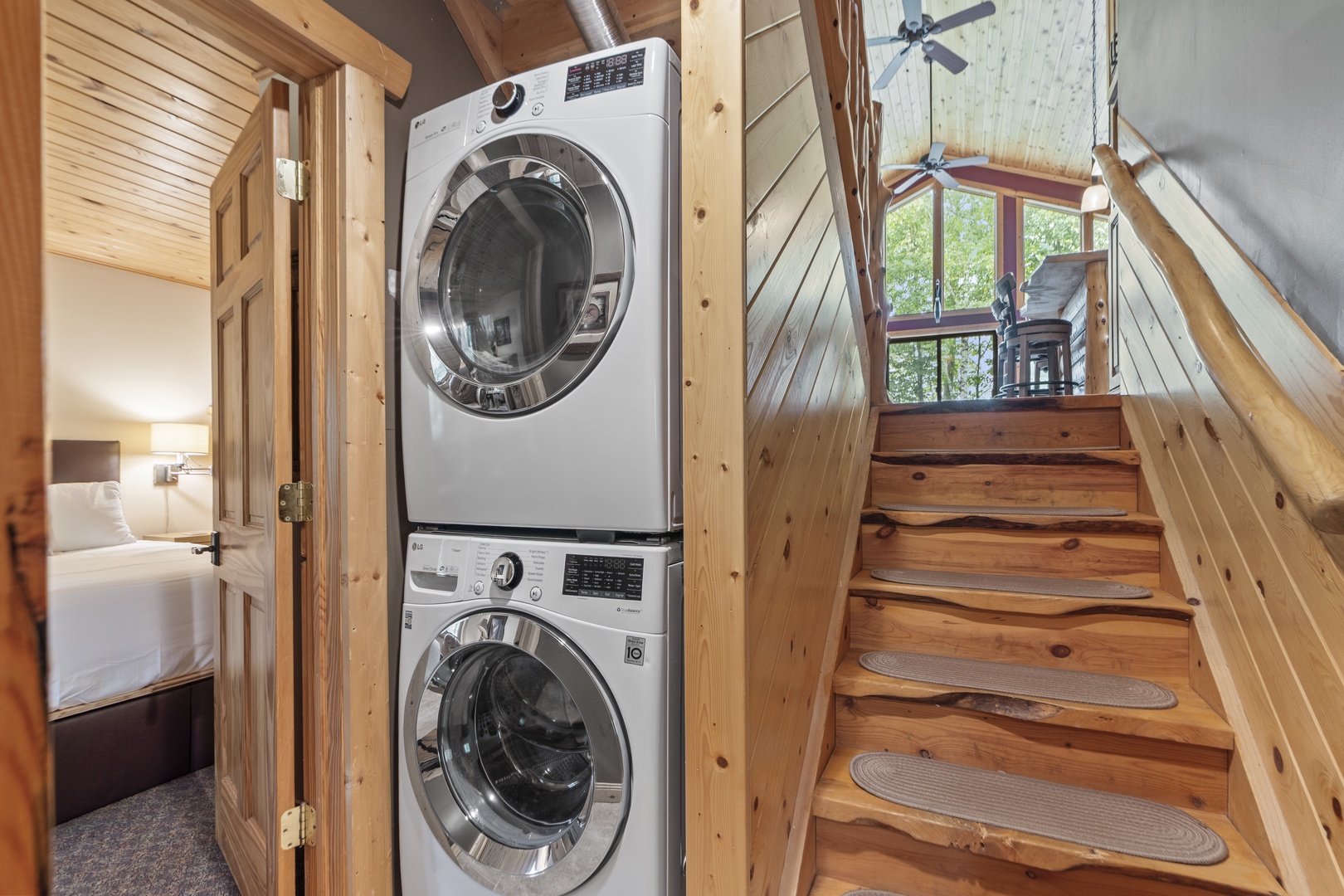 Your own stacked washer and dryer keeps laundry easy during your stay, tucked neatly in this charming cabin nook.