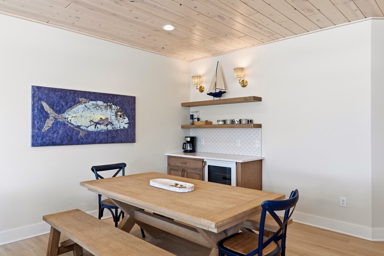 Rustic farmhouse dining table with nautical art and coffee bar