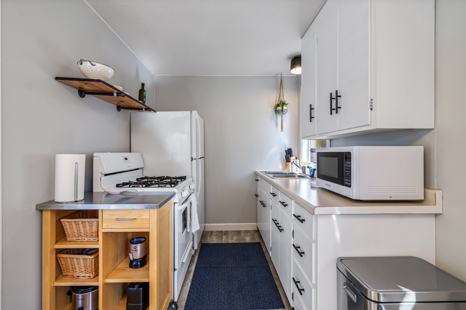 19 — Fully Equipped Galley Kitchen with Gas Stove Microwave and Rolling Island Cart