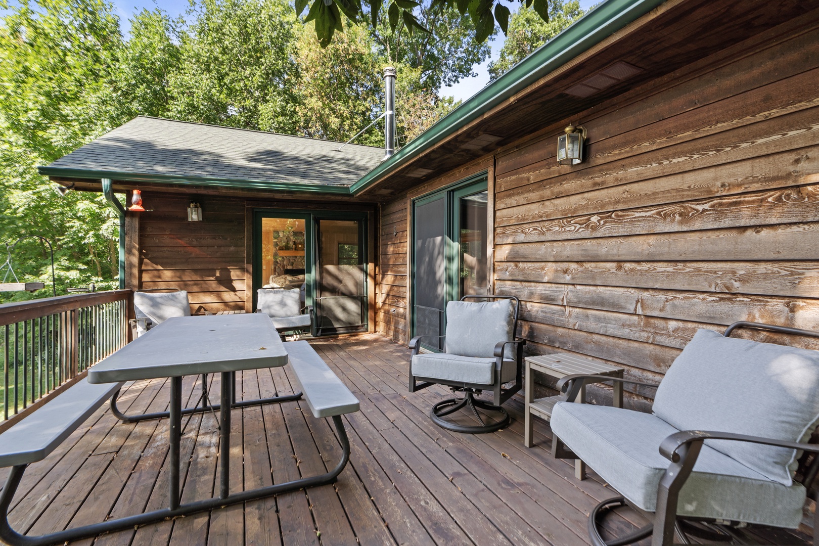 Step onto your private deck, nestled among the trees, where morning coffee or evening relaxation feels like your own secluded retreat with comfortable seating and fresh air.