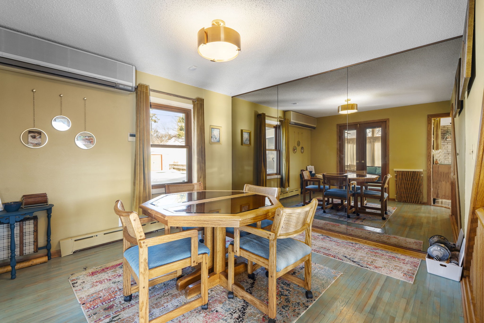 Your spacious dining room features warm wood tones, comfortable seating, and natural light streaming through windows creating the perfect atmosphere for memorable meals.