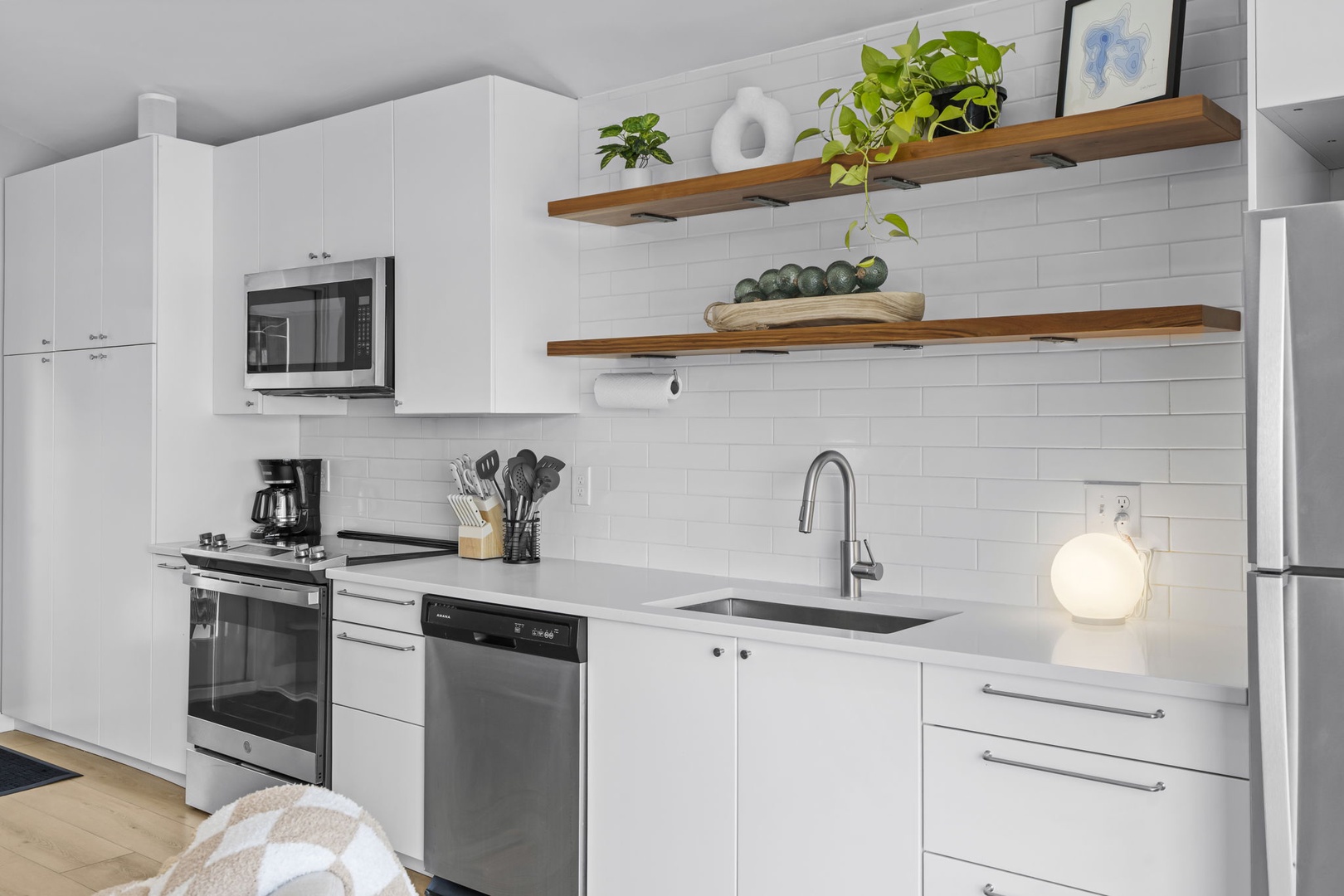 This bright, modern kitchen features everything you need to prepare meals, with sleek appliances and thoughtful details.
