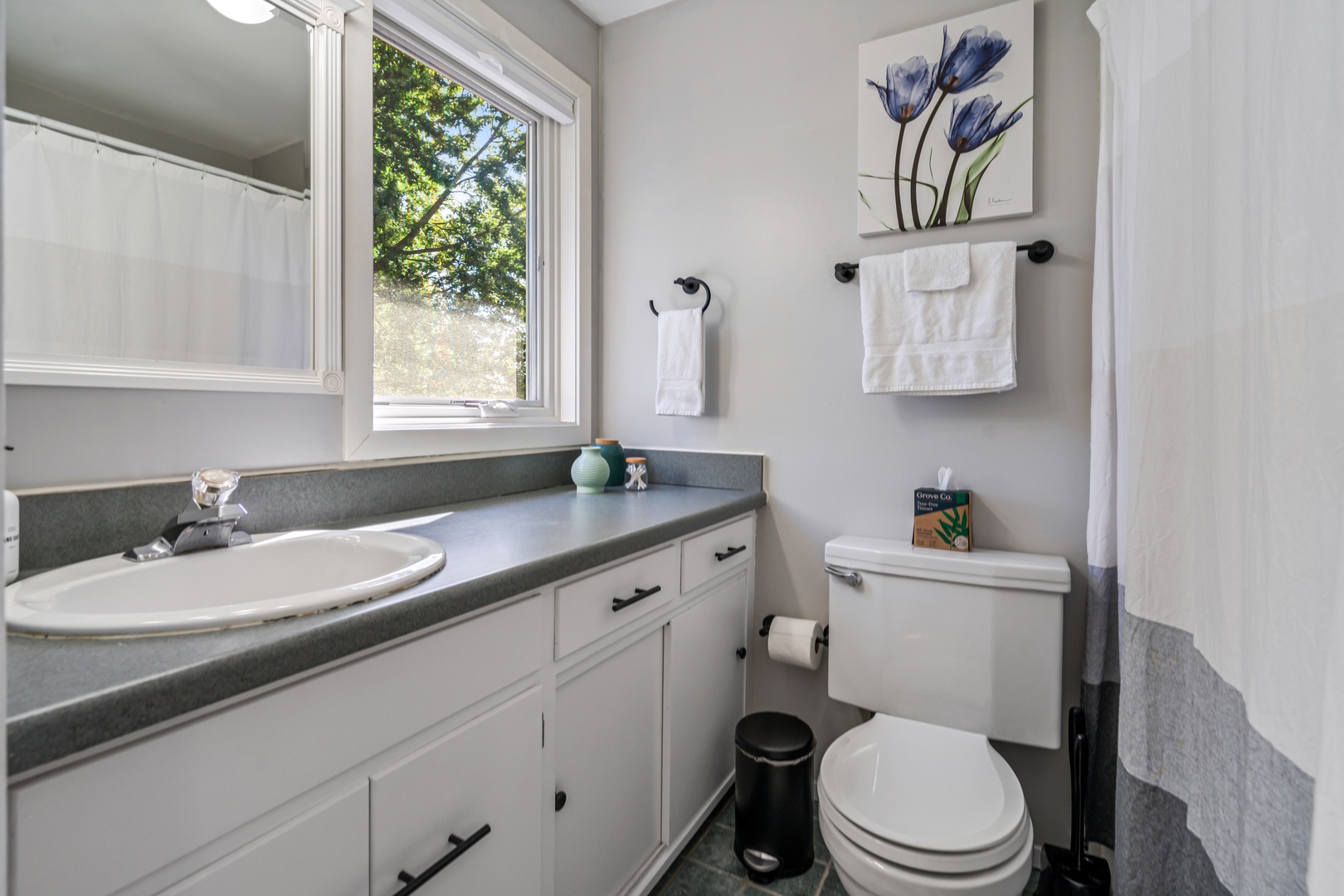 30 — Clean Bright Bathroom with Full Vanity Natural Light and Fresh Towels