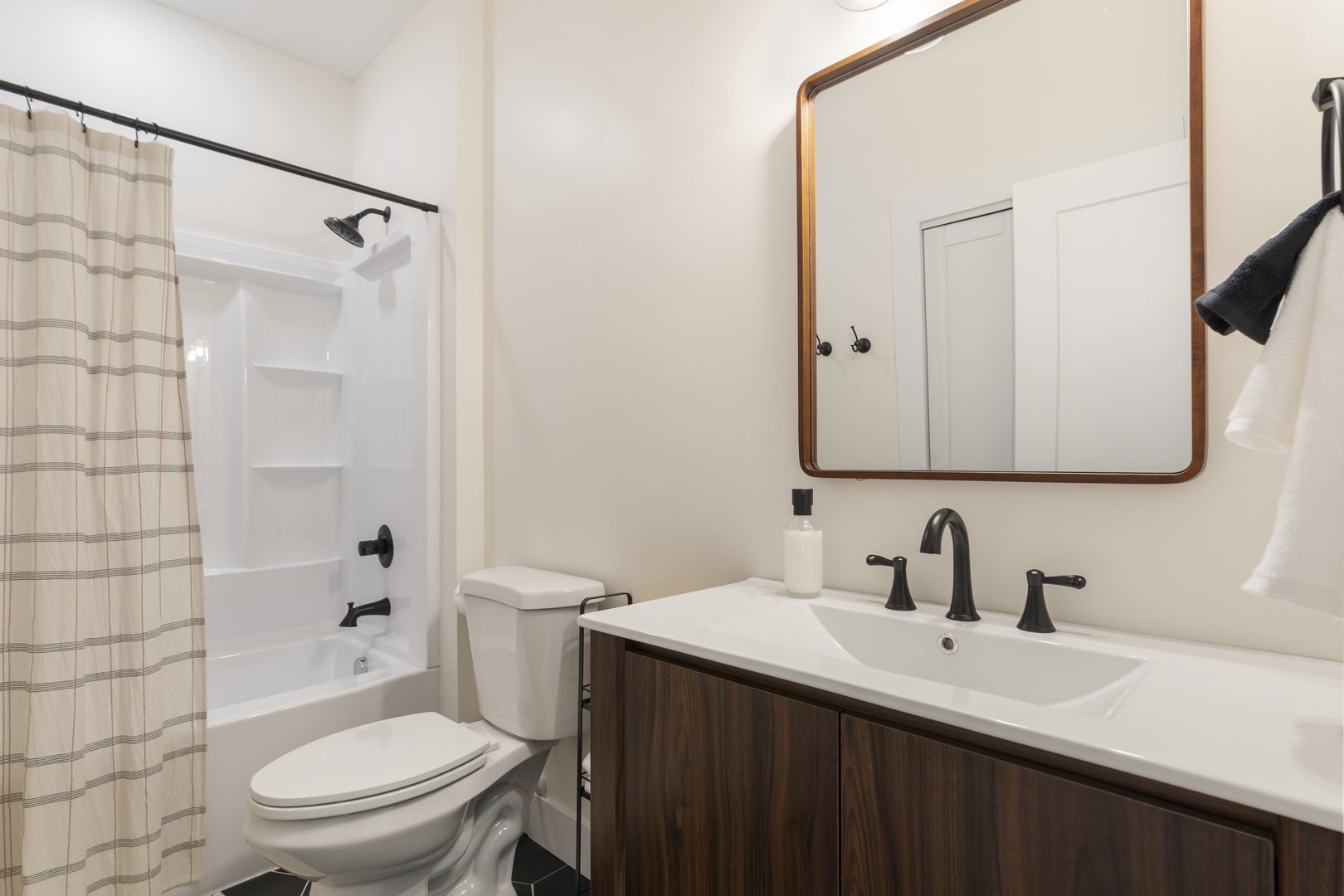 This bright, modern bathroom is ready for your refresh after a day of exploring. The clean lines, handy storage, and warm wood tones make your daily routine feel a little more special.