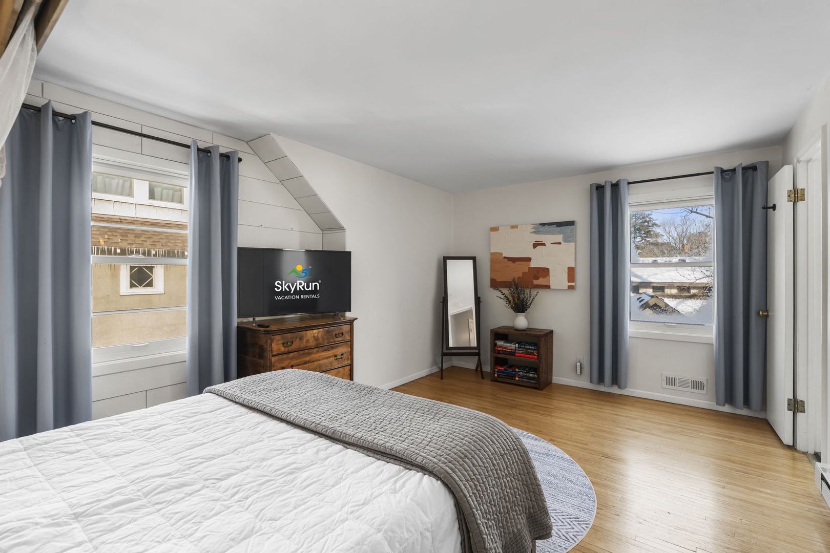 Wake up to charming views from your bright bedroom, featuring warm wood floors and cozy furnishings for restful nights.
