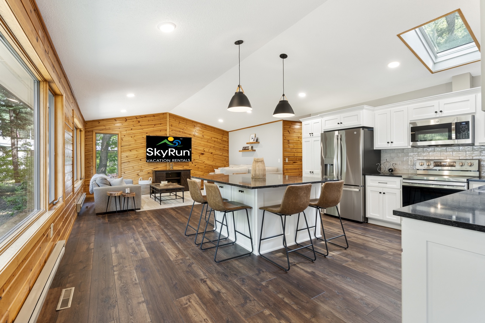 Gather around the kitchen island and share stories as natural light pours in through the skylight, creating a warm and airy space perfect for cooking together and enjoying your vacation meals.