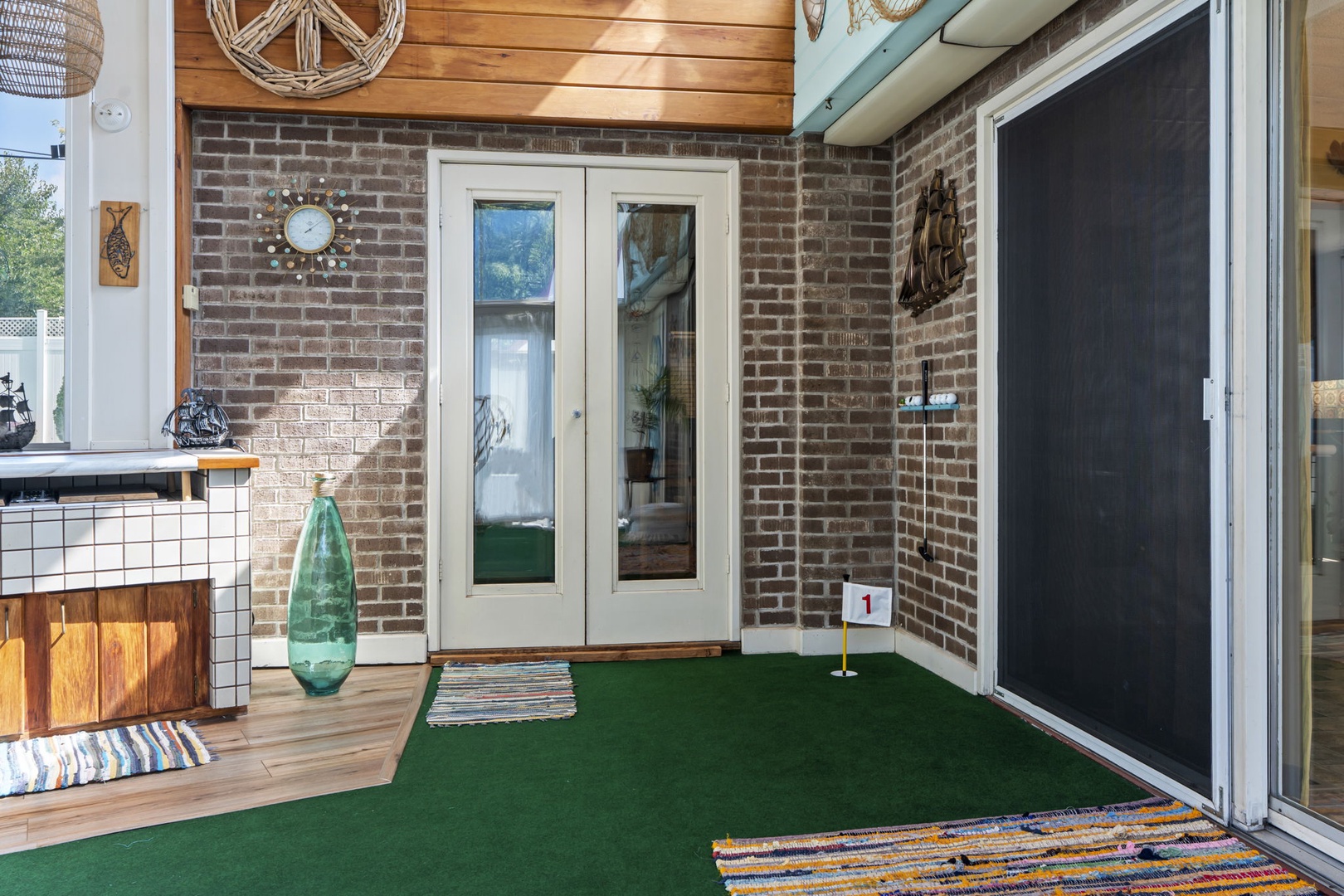 Your private patio features a fun putting green where you can practice your golf swing surrounded by charming brick walls and bohemian touches.