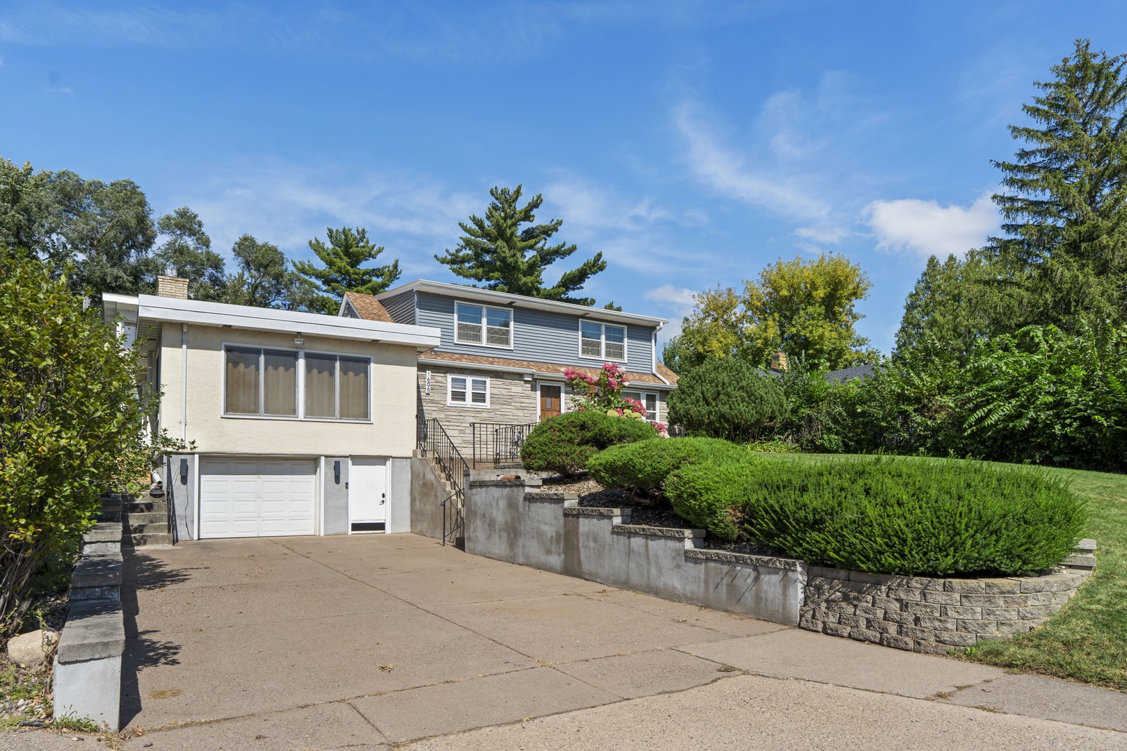 Modern two-story home featuring a peaceful residential setting with mature trees and well-maintained landscaping throughout the neighborhood.