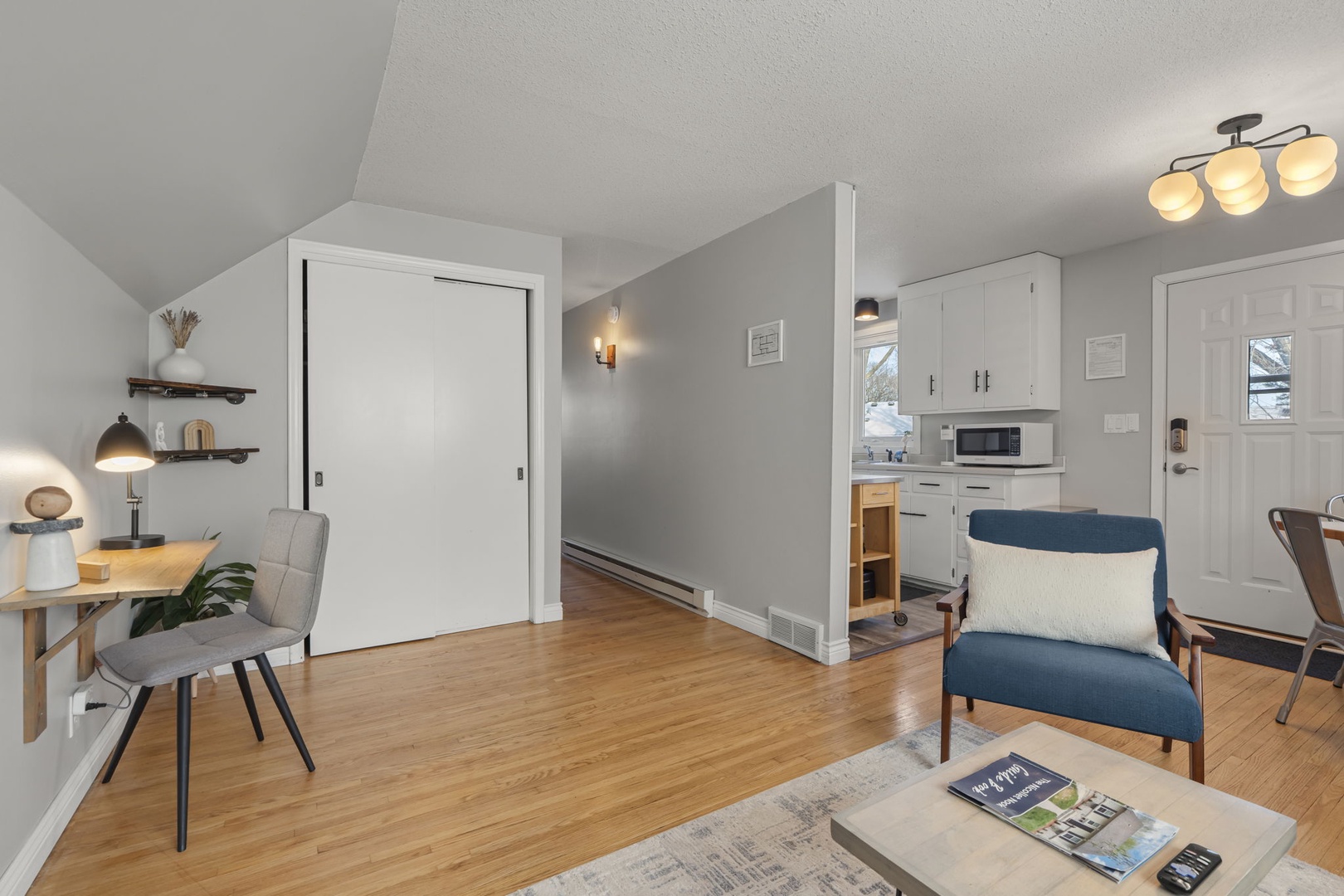 Relax in your thoughtfully designed space with gleaming hardwood floors, modern furnishings, and a fully equipped kitchen for your comfort.