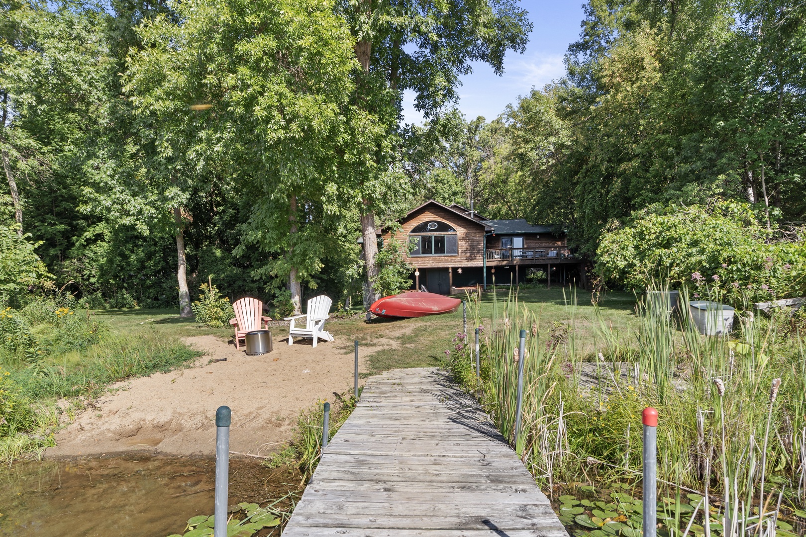 A scenic waterfront retreat nestled among towering trees, with a private dock leading to your lakeshore cabin. Relax in Adirondack chairs, launch the kayak, and unwind in the embrace of nature.