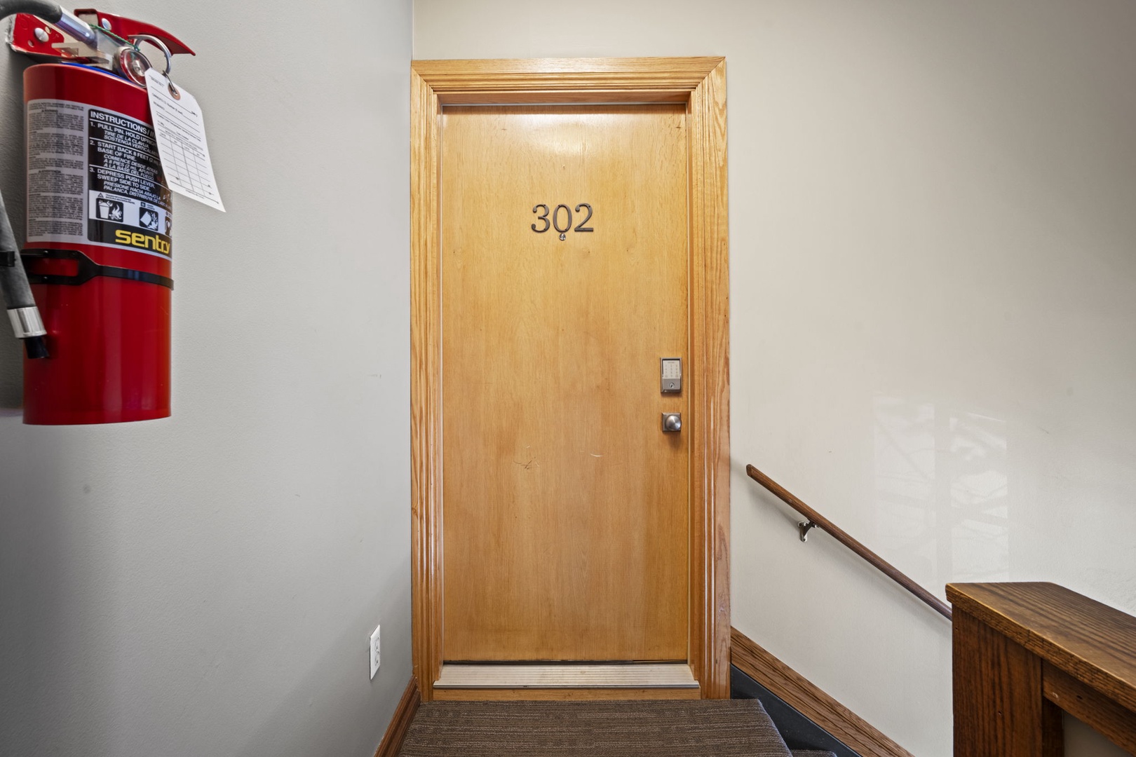 Your entry awaits at room 302, where a clean hallway and secure door welcome you to your private retreat.