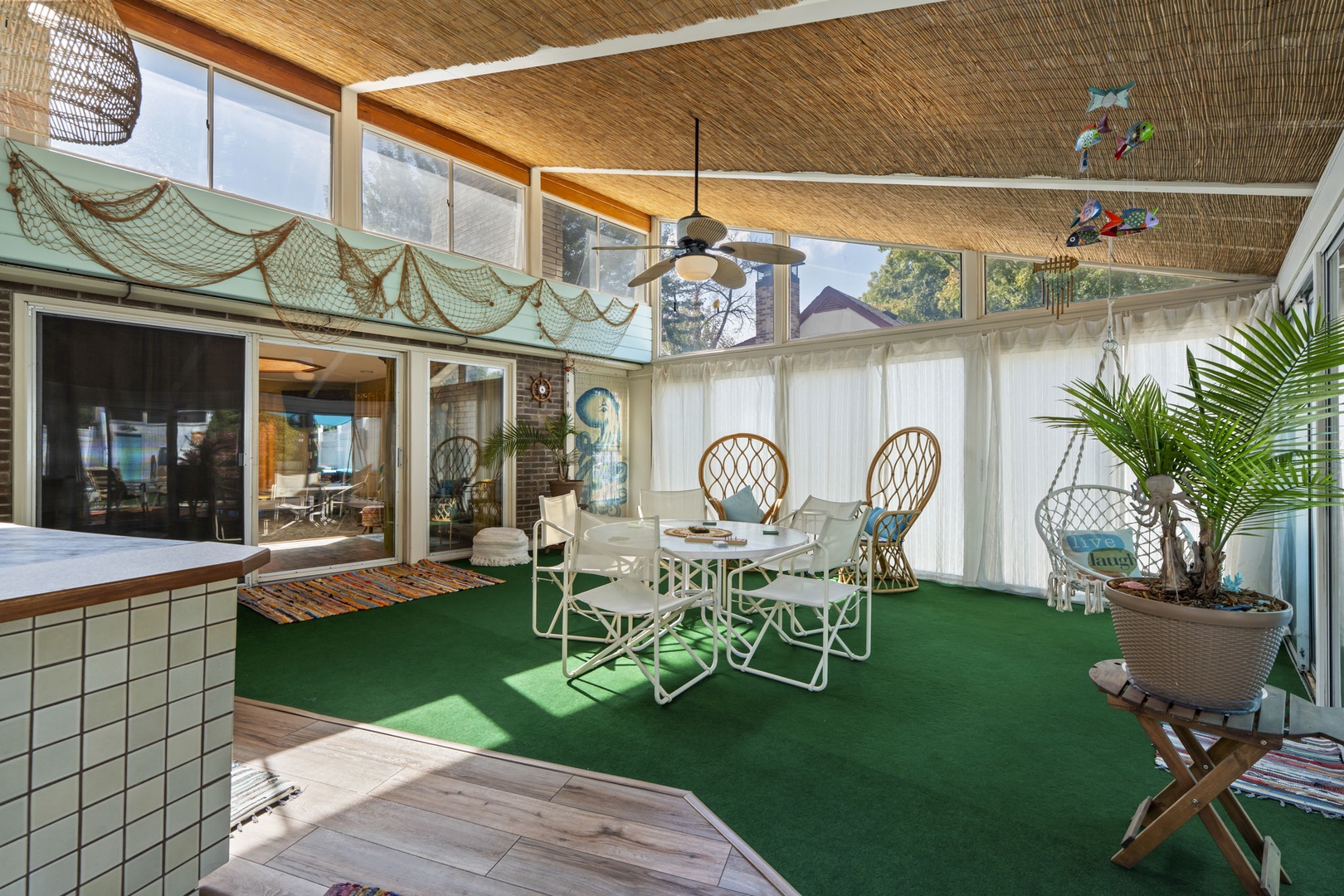 Step into the 3 season porch, your private oasis with bamboo ceilings, unique decor, and dining space perfect for memorable meals.