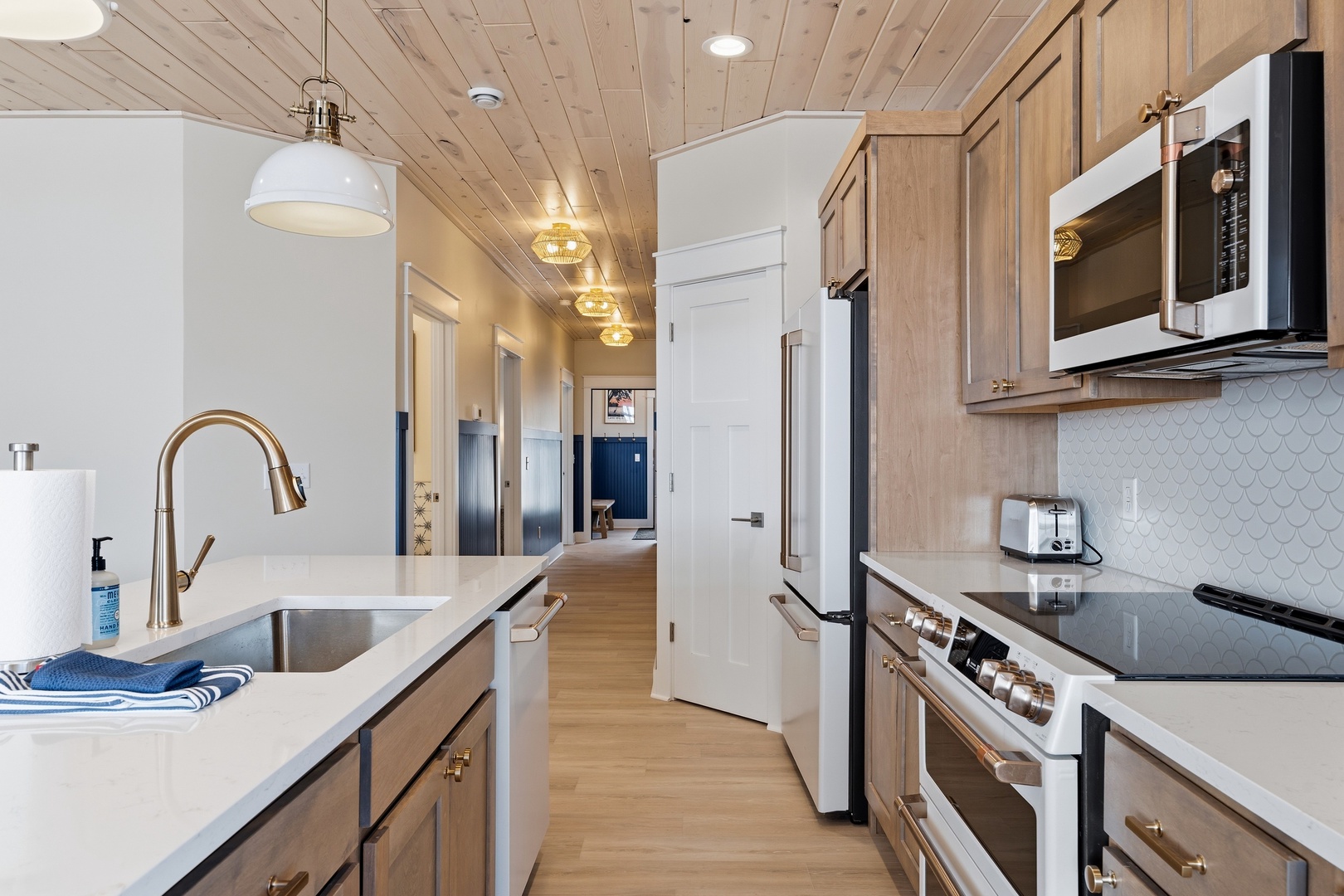 Designer kitchen with stainless steel appliances and gold fixtures